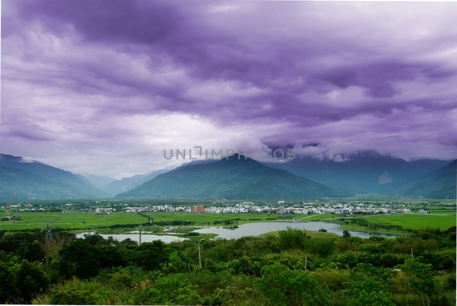 It is a beautiful mountain and clouds with tree.