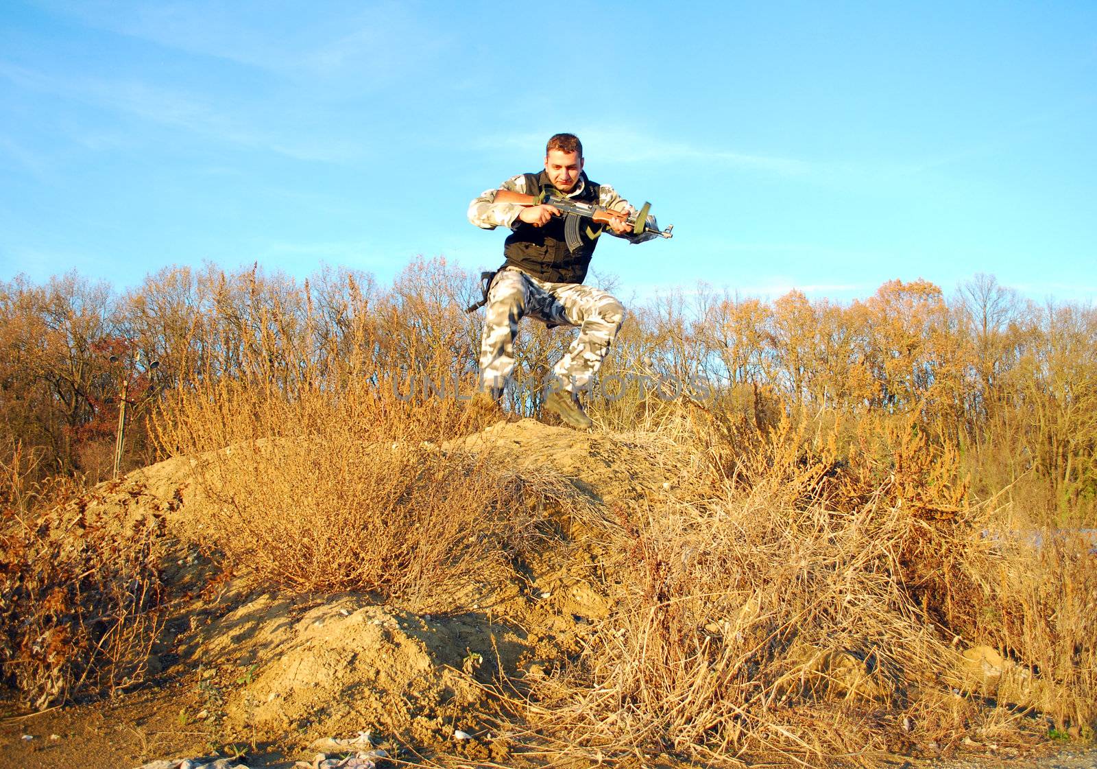 Military physical training, making jump�s with weapon in his hands