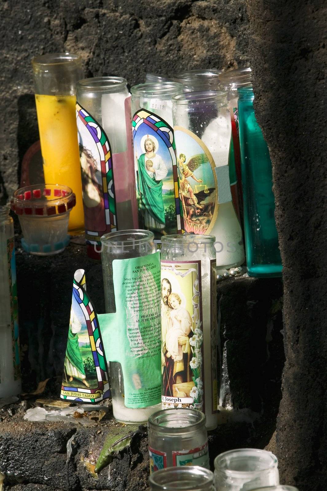Catholic devotional candles on an outdoor stone altar
