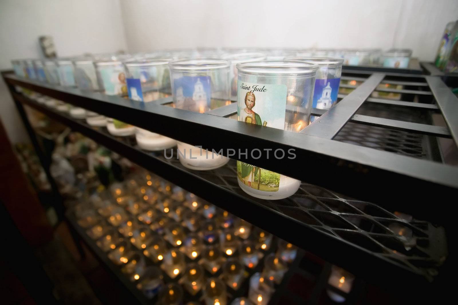 Devotional Candles in a Catholic Church by Creatista