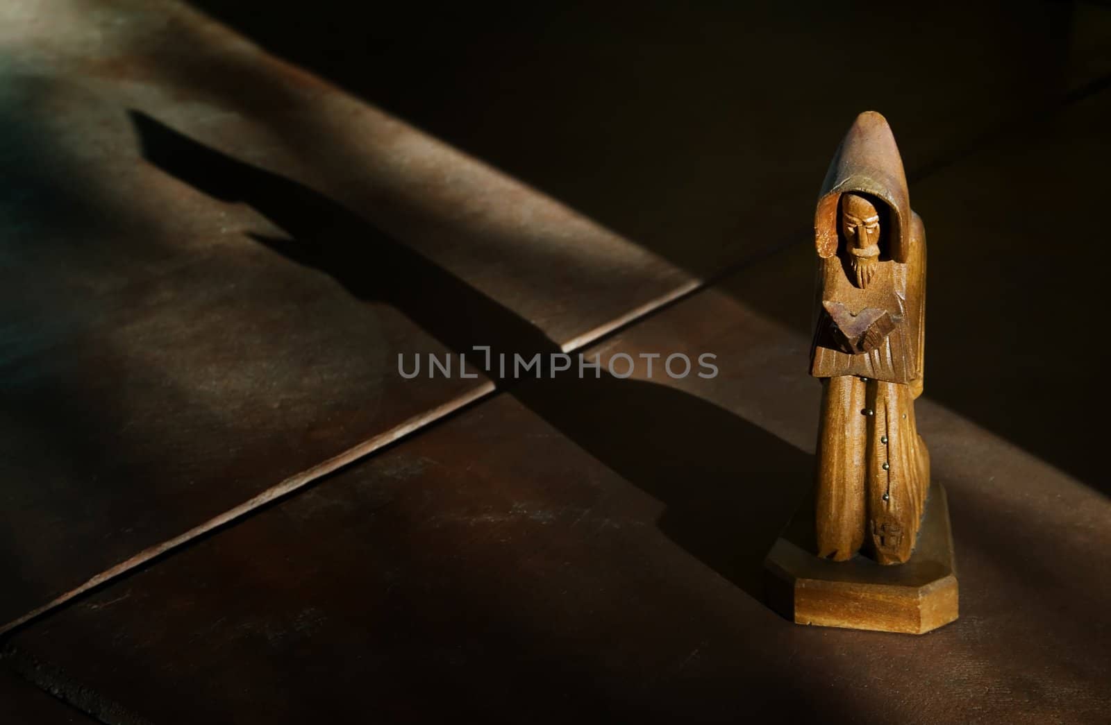 Wooden Statue of St. Francis in Afternoon Light with Shadow