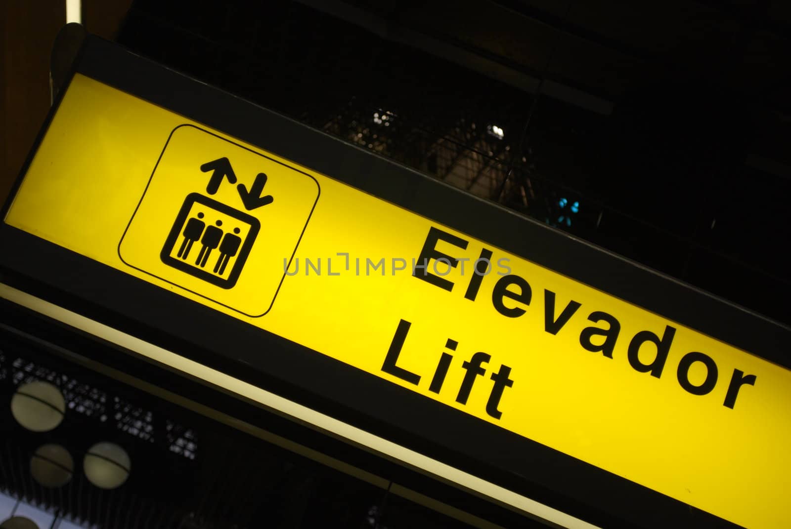 yellow and black elevator sign at a international airport