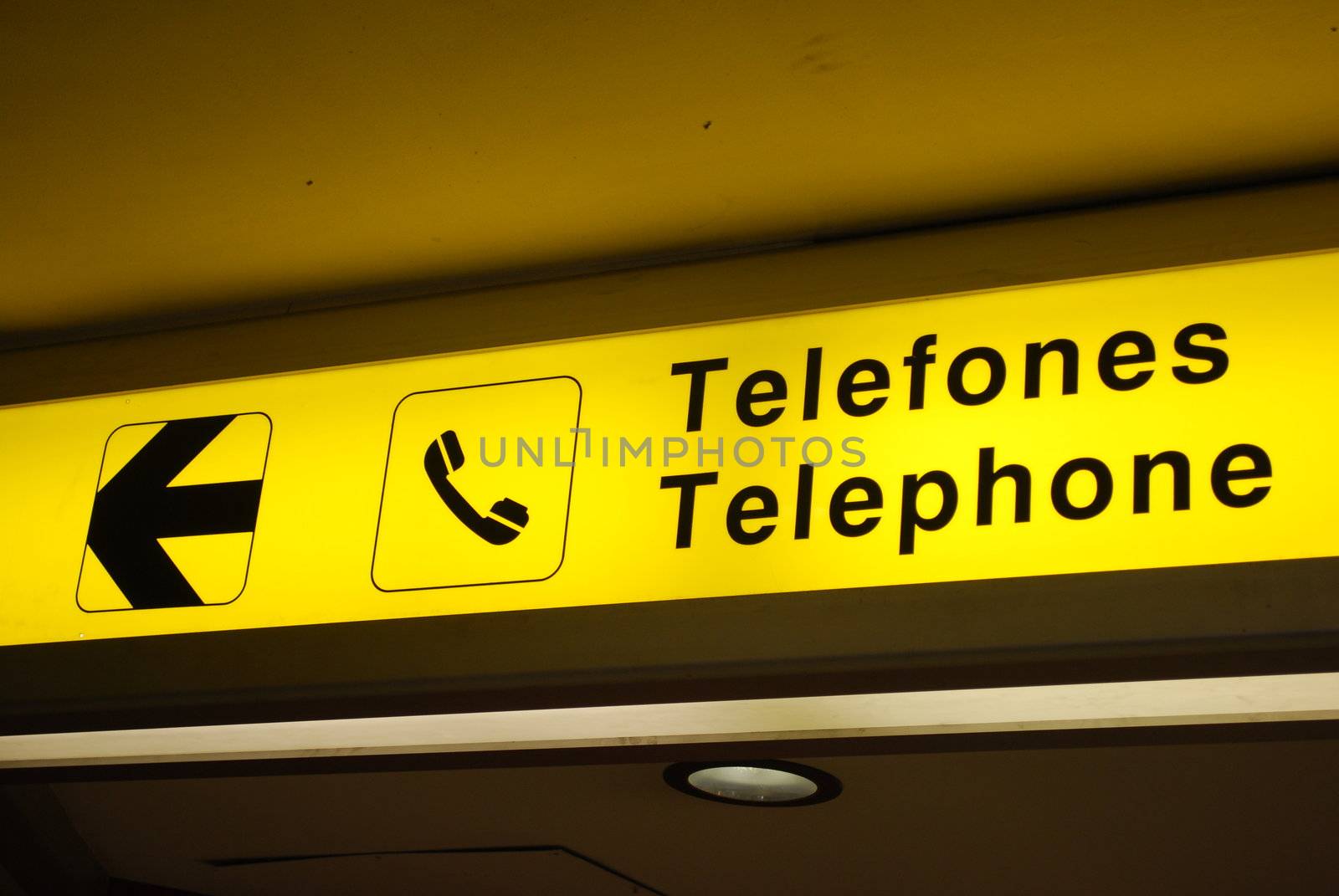 yellow and black telephone sign on international airport