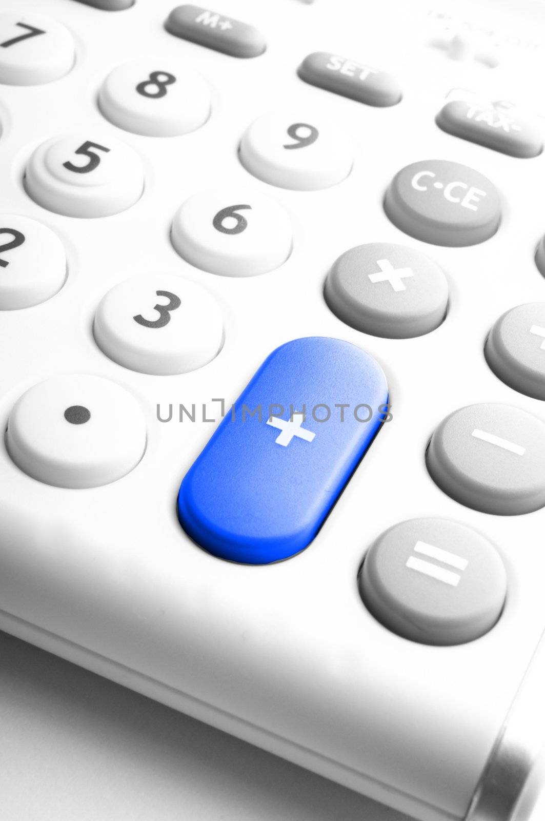 adding up figures concept with modern white calculator in office