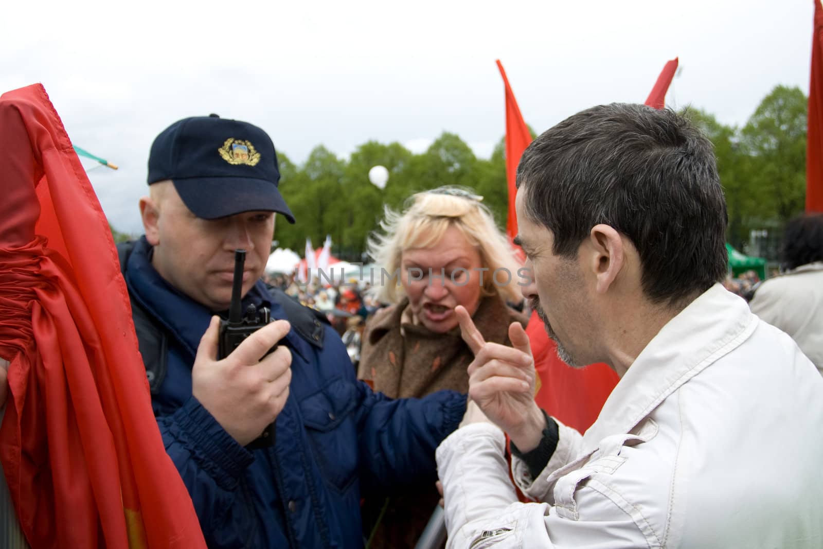 RIGA, LATVIA, MAY 9, 2009: Vladimir Linderman, member of the banned National Bolshevik party (NBP) is arrested for using forbidden Soviet Union flag. Celebration of May 9 Victory Day (Eastern Europe) in Riga at Victory Memorial to Soviet Army