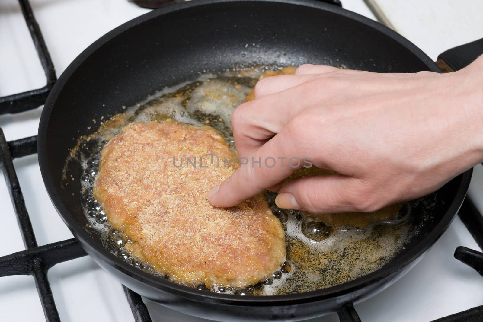 Chicken cutlets roasting on frying-pan