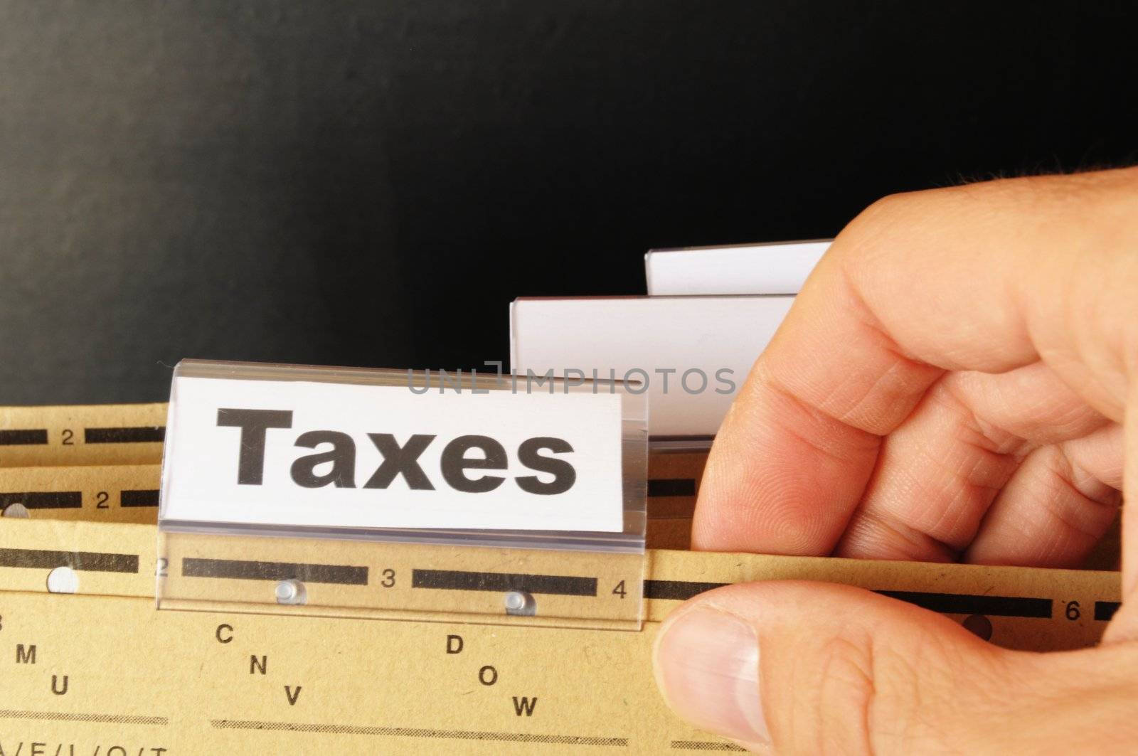 tax or taxes concept with word on business folder index