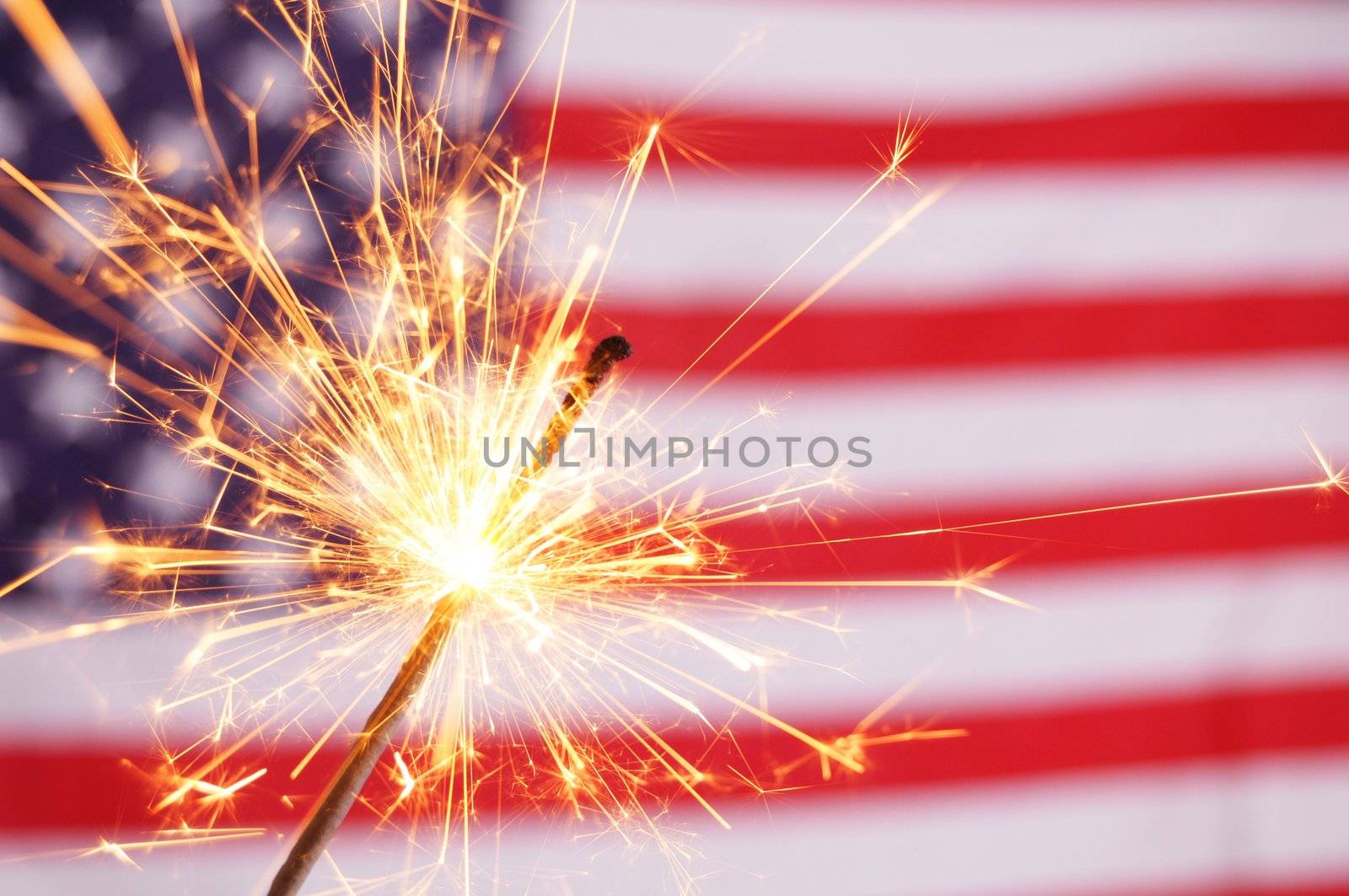 sparkler and usa flag showing 4th of july