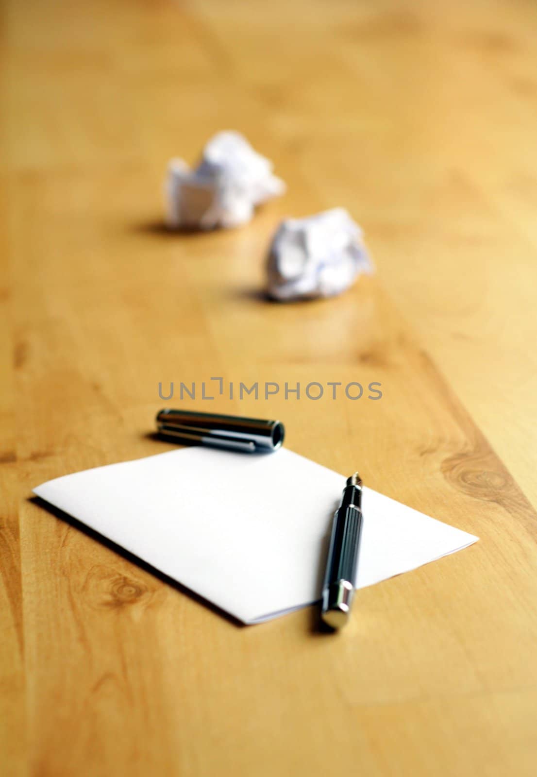 pen and paper in a wooden desktop showing creativity concept