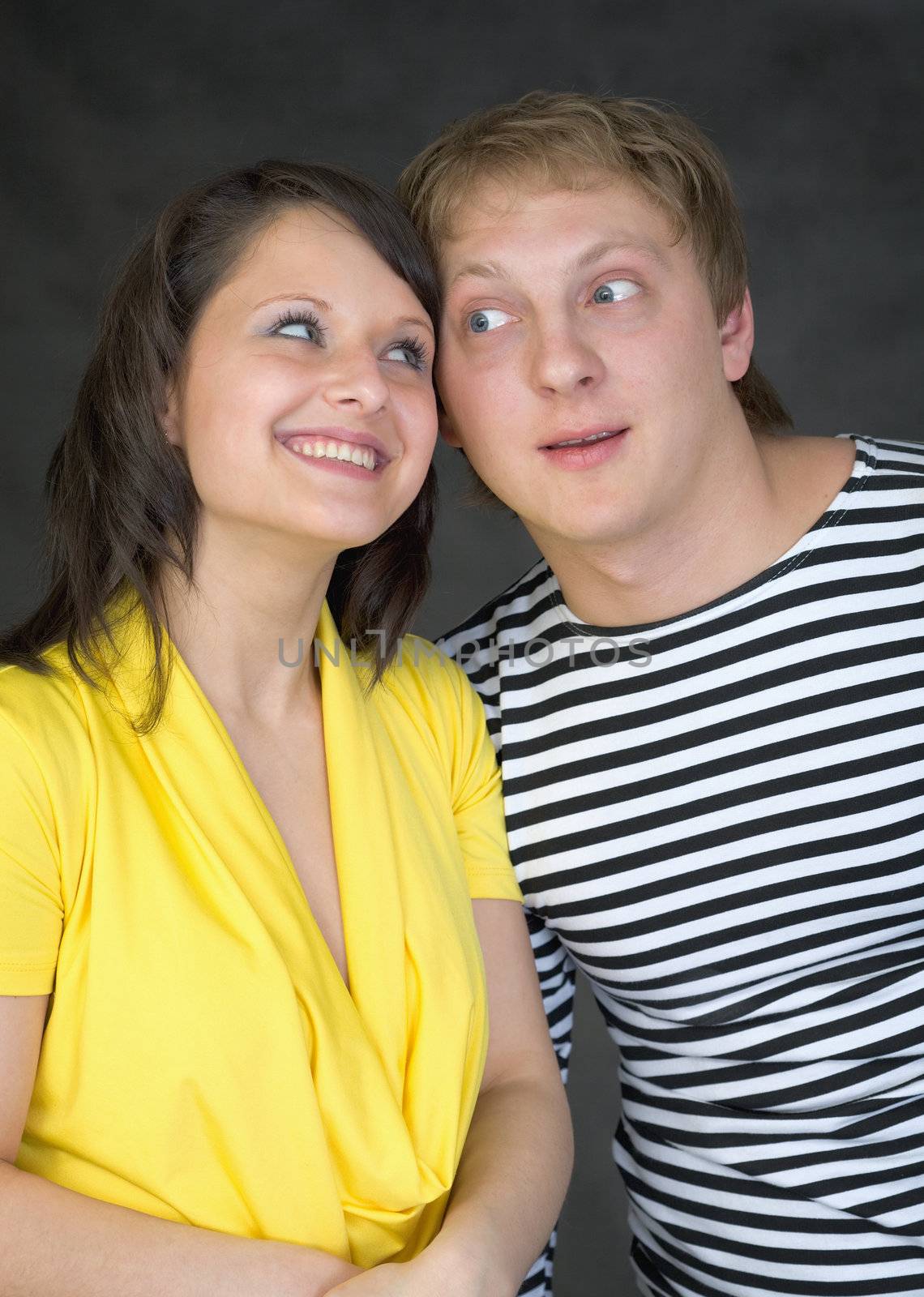 Amusing young pair on a black background