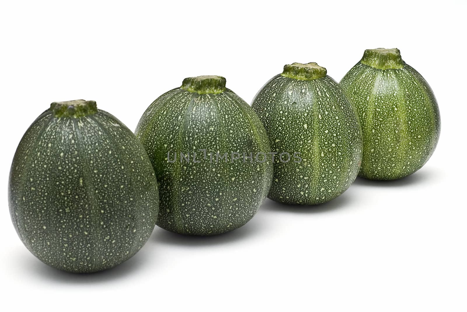 Round zucchini isolated on a white background.