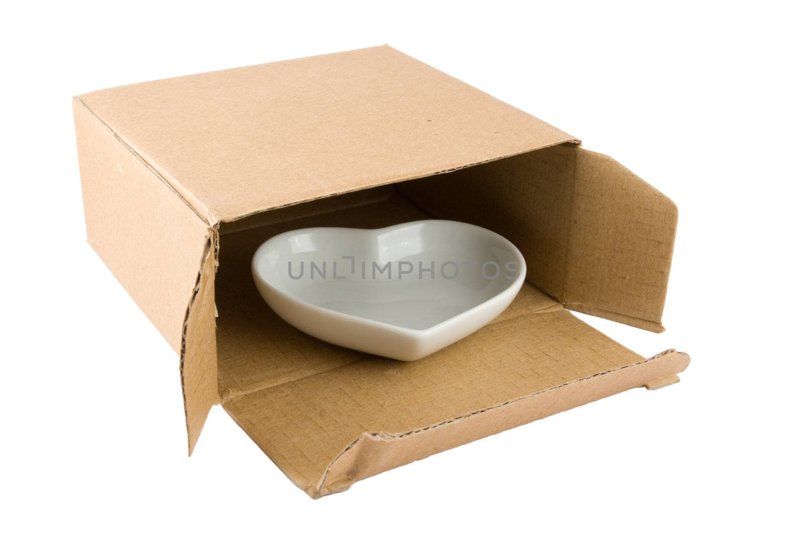 Ceramic Heart in Cardboard Box isolated on a white background