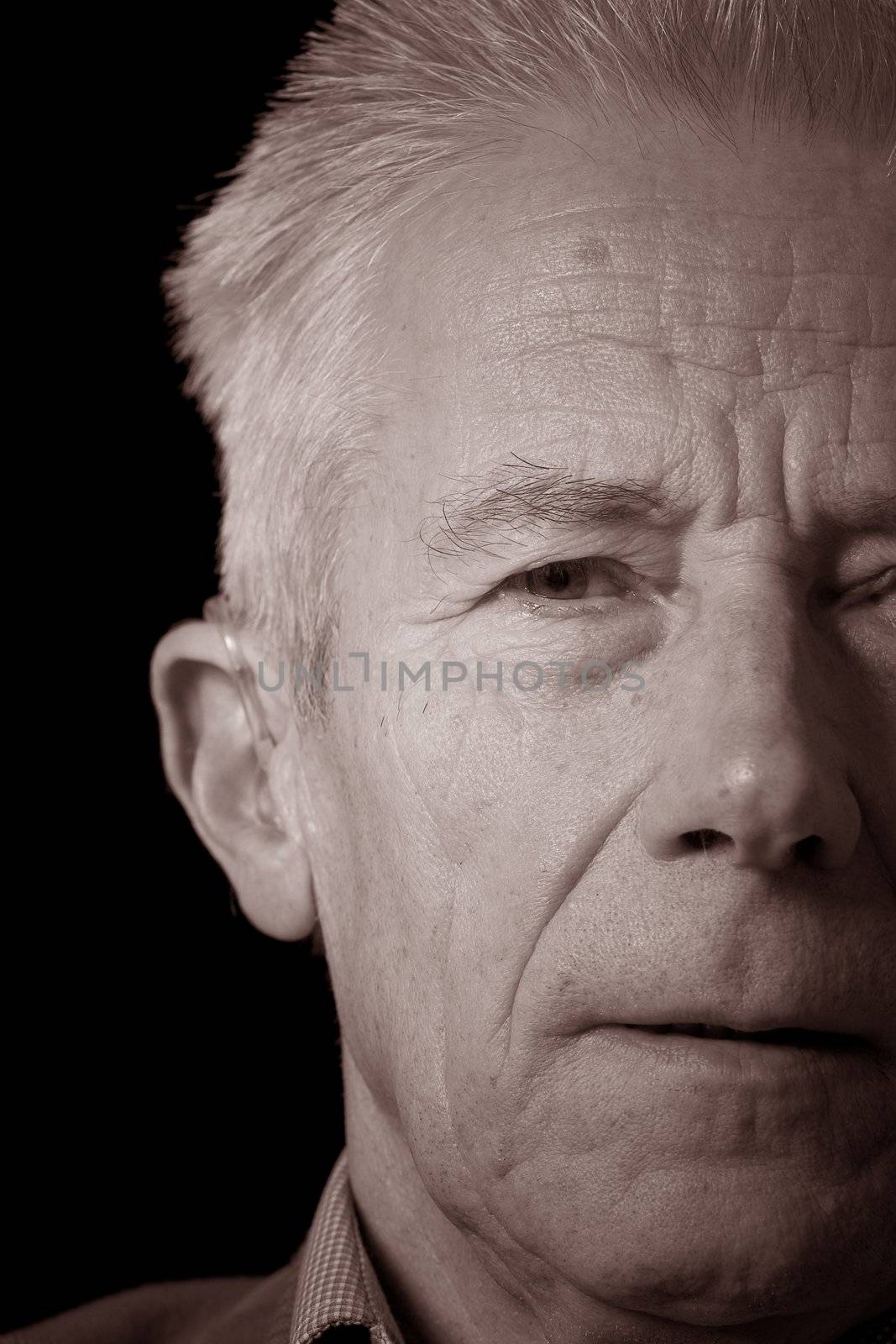 Senior man in sepia portrait by Fotosmurf