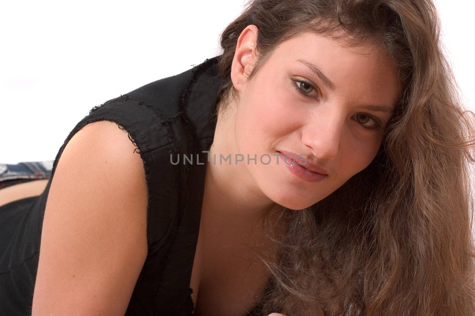 Beautiful young girl lying on white background