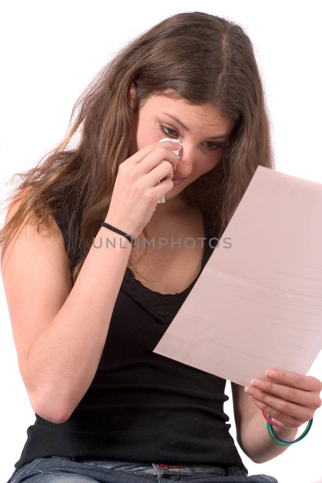 Young woman reading a letter and about to start crying