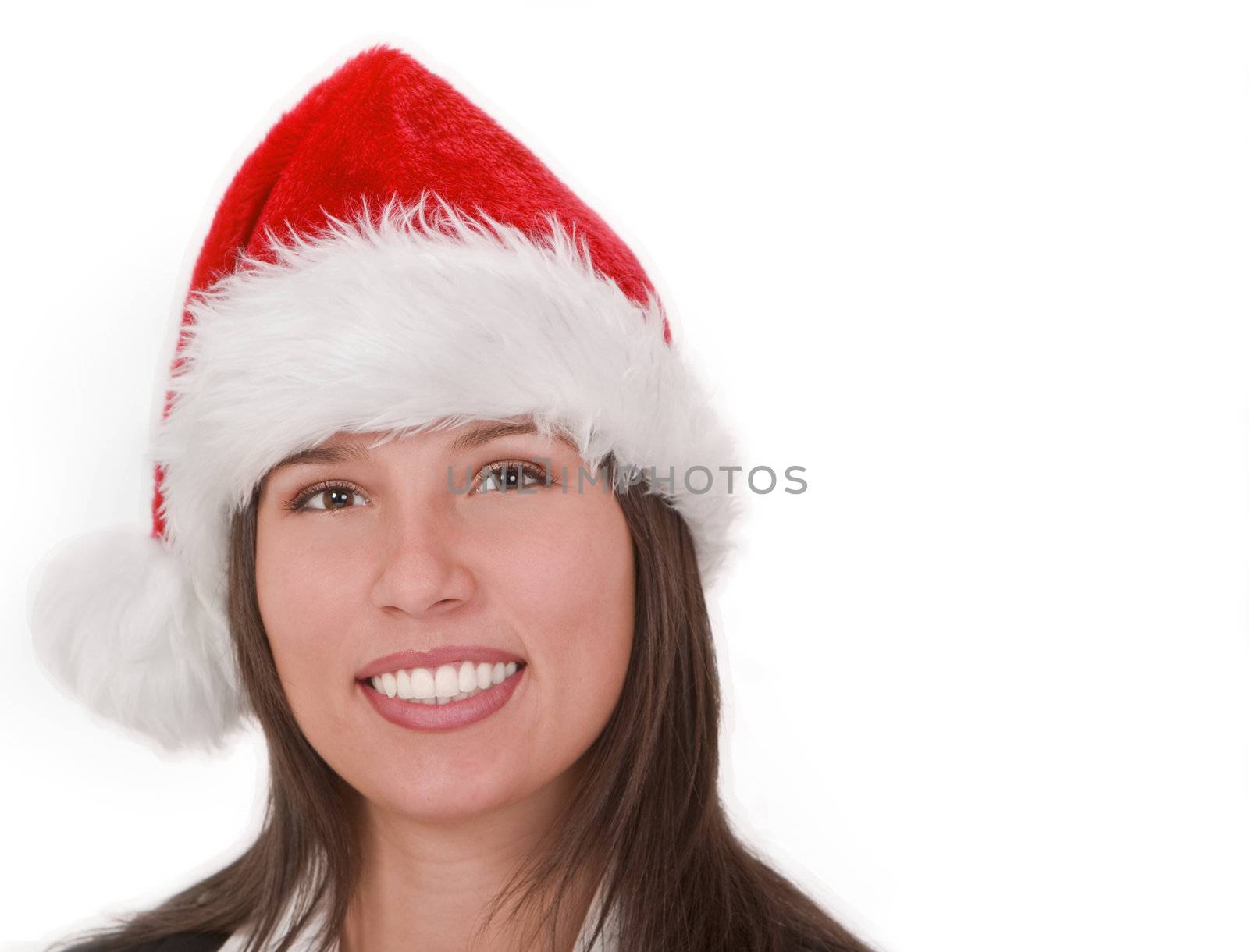 Portrait of a smiling girl wearing a red Santa's hat.