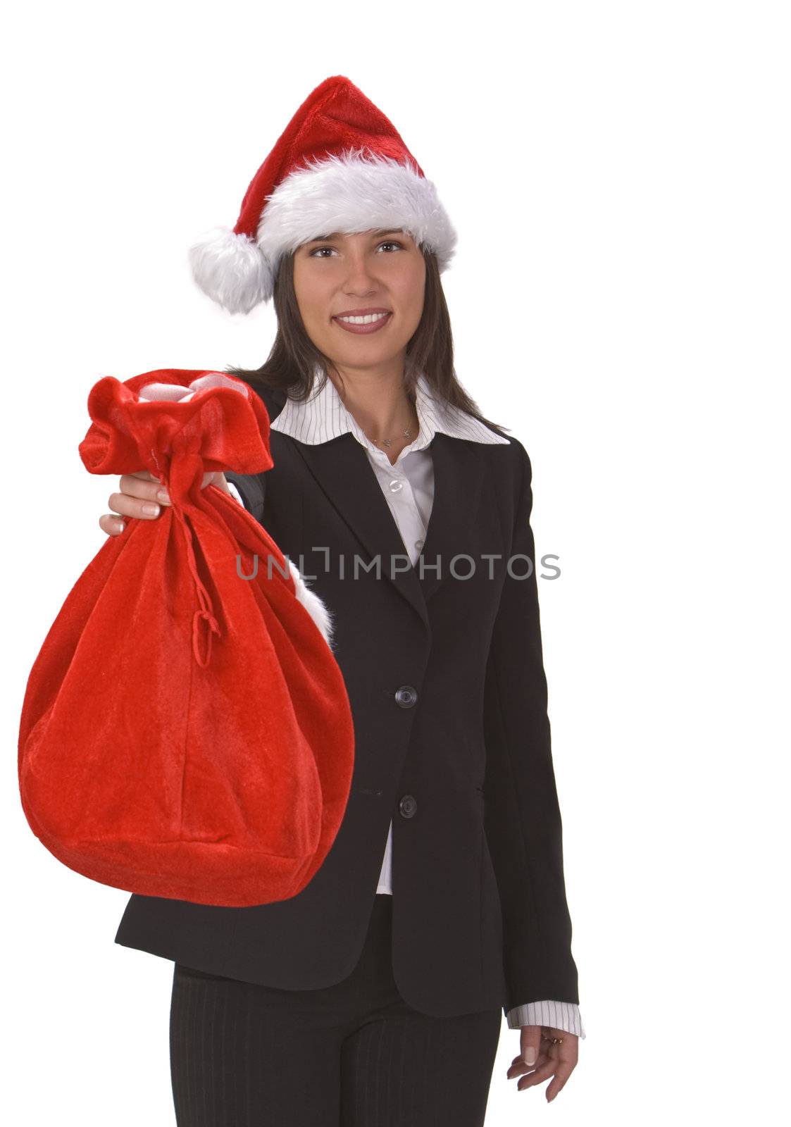 Young businesswoman wearing a Santa's hat and offering a red sack full of gifts. 