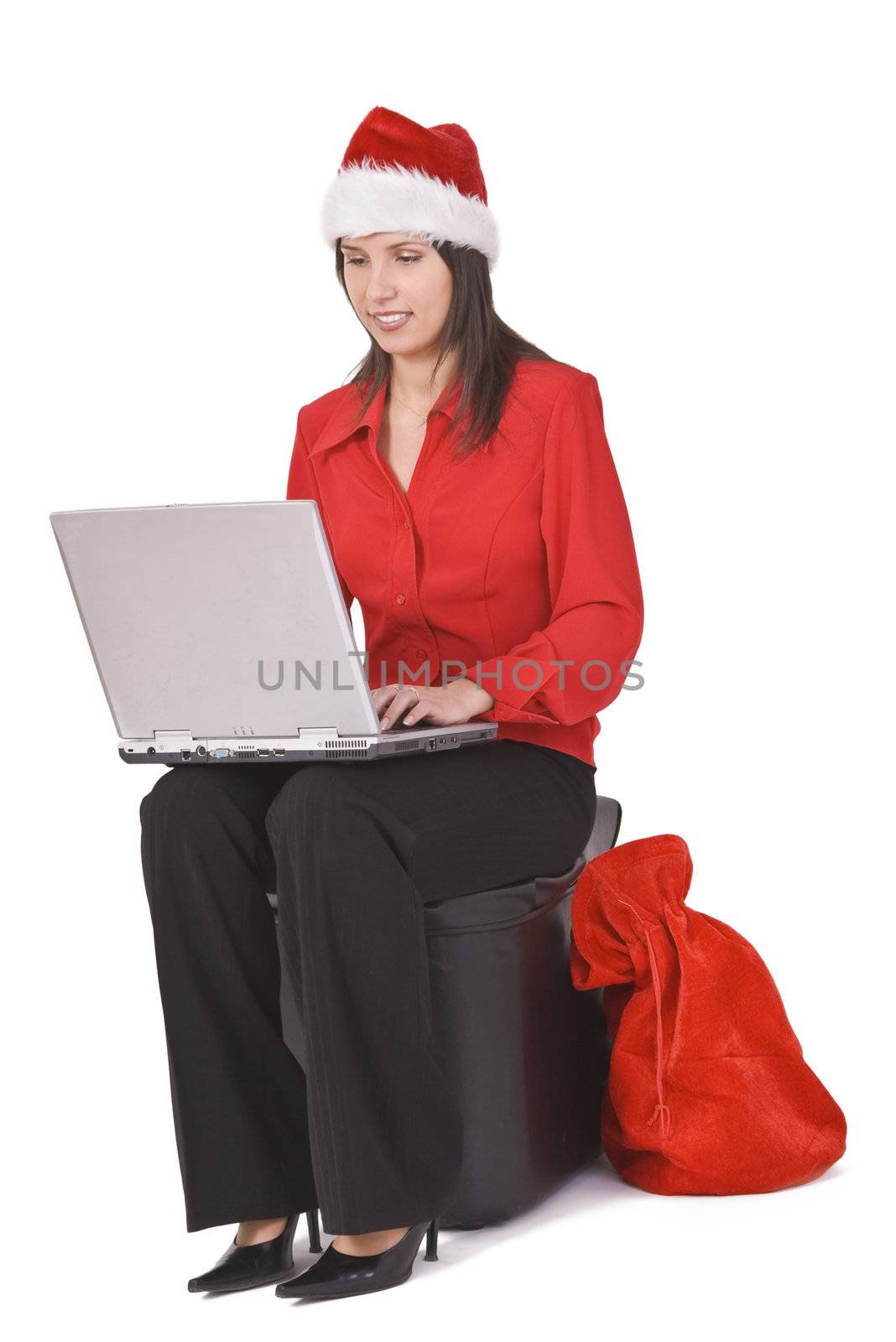 Young woman in red clothes and hat working on a laptop. Shot with Canon 70-200mm f/2.8L IS USM