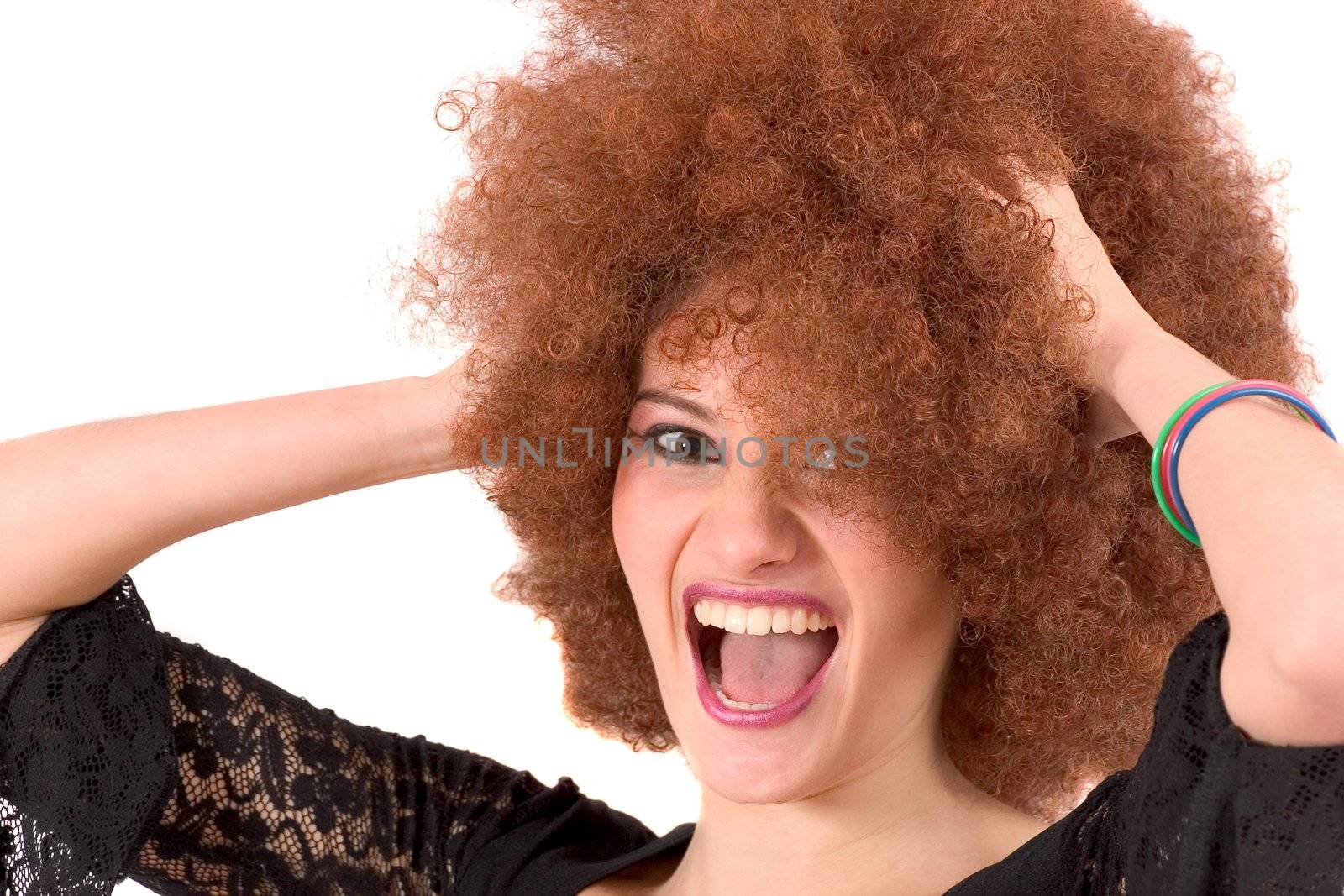 Beautiful young teenager screaming while holding her  red afro wig