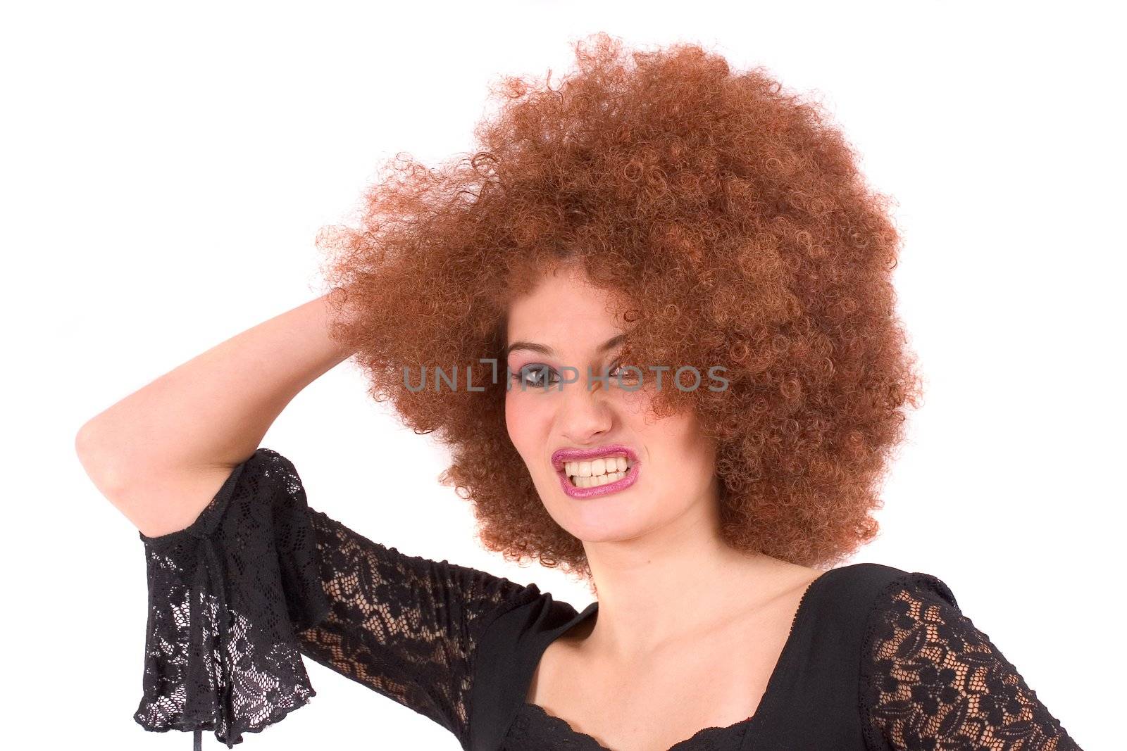 Beautiful young teenager with red afro wig pulling a face