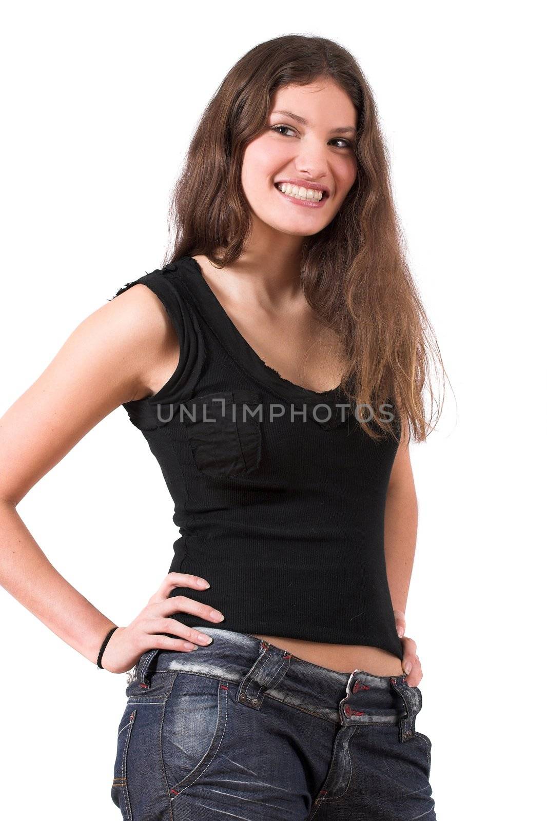 Beautiful teenager standing in a confident pose with her hands on her hip and smiling