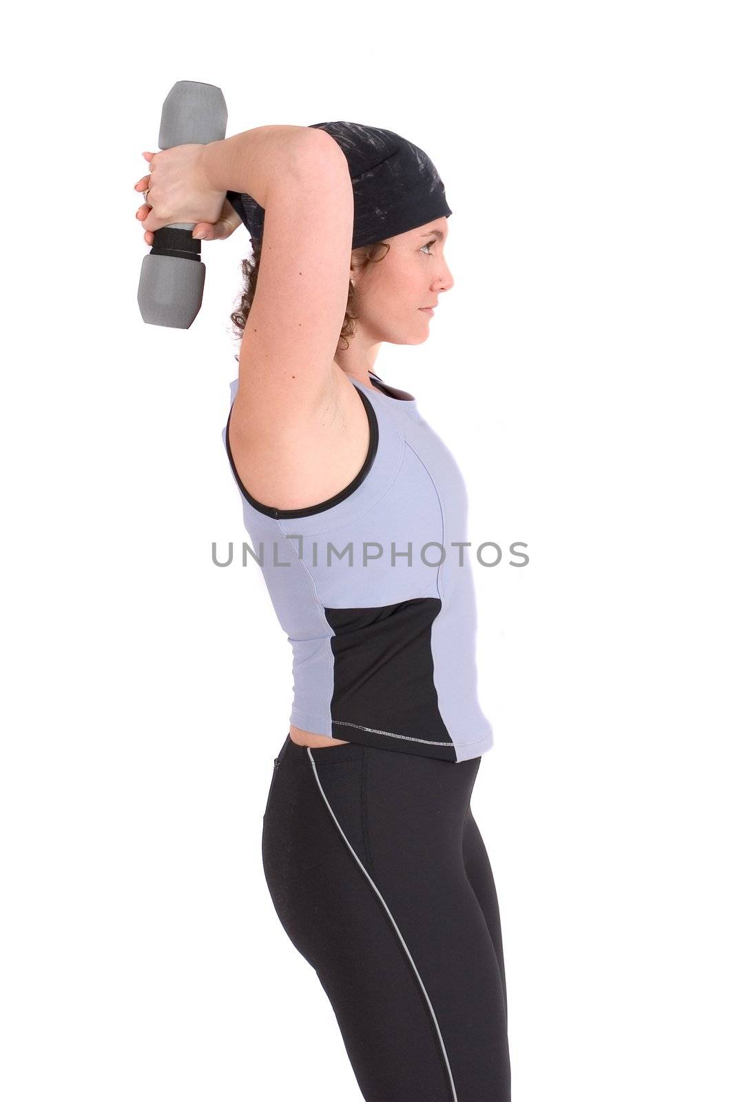 Attractive young woman doing triceps curls standing