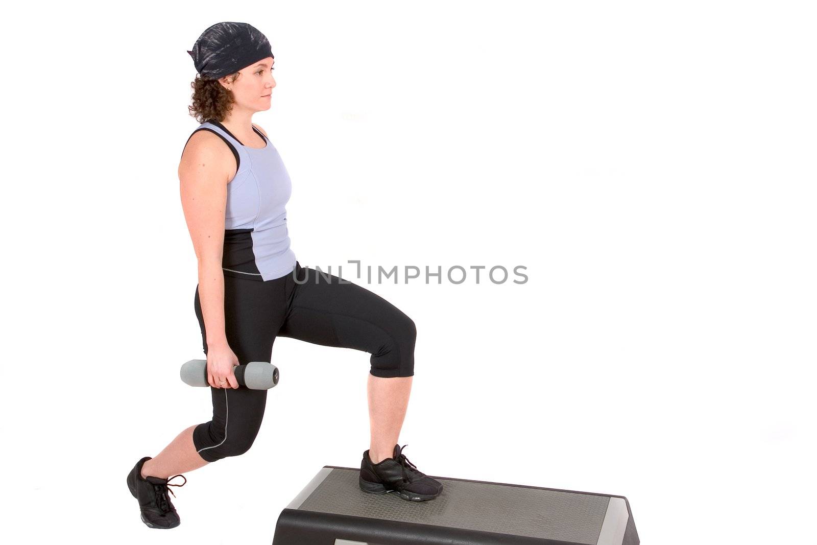 Attractive woman doing squats while holding weights