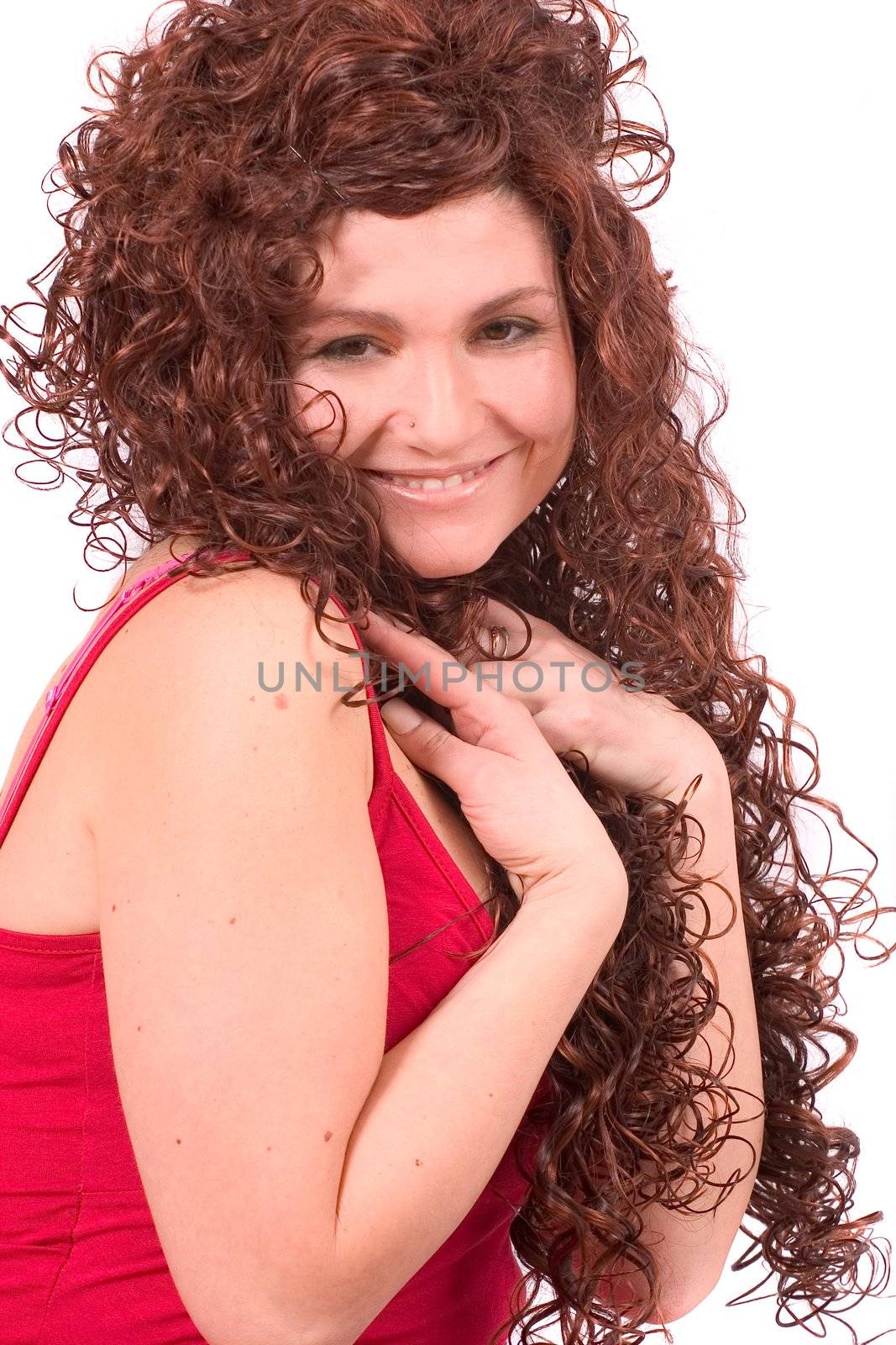 Beautiful young woman with long red curly hair