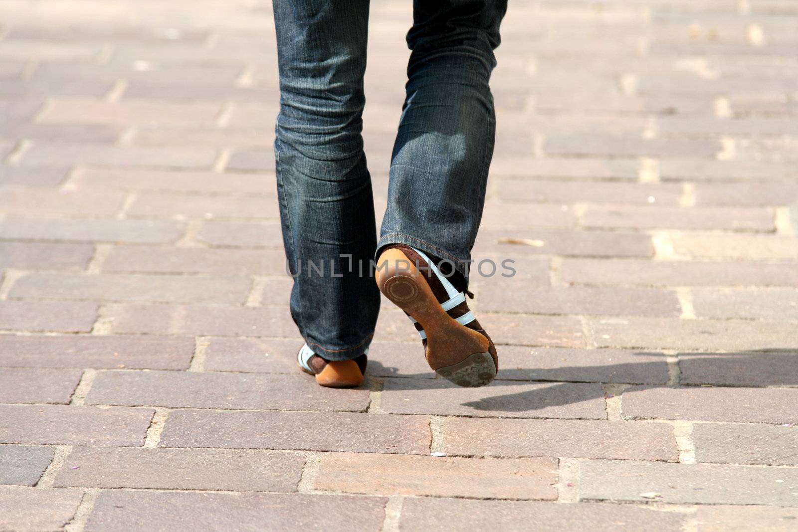 Human legs with blue jeans and shoes