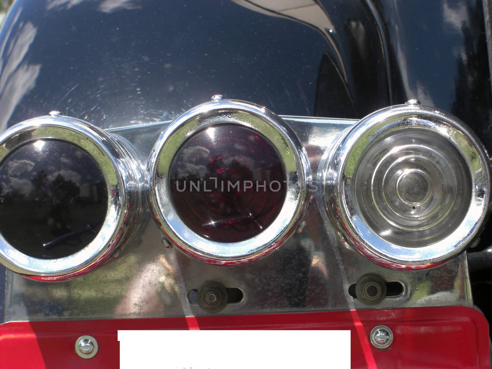 An unusually designed set of rear lights of an antique car.
