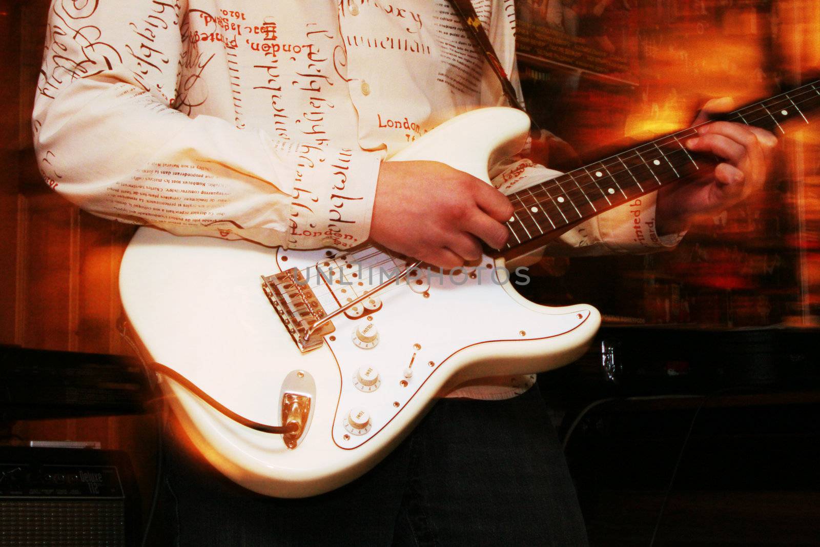 The guitarist in a white shirt plays on a white guitar