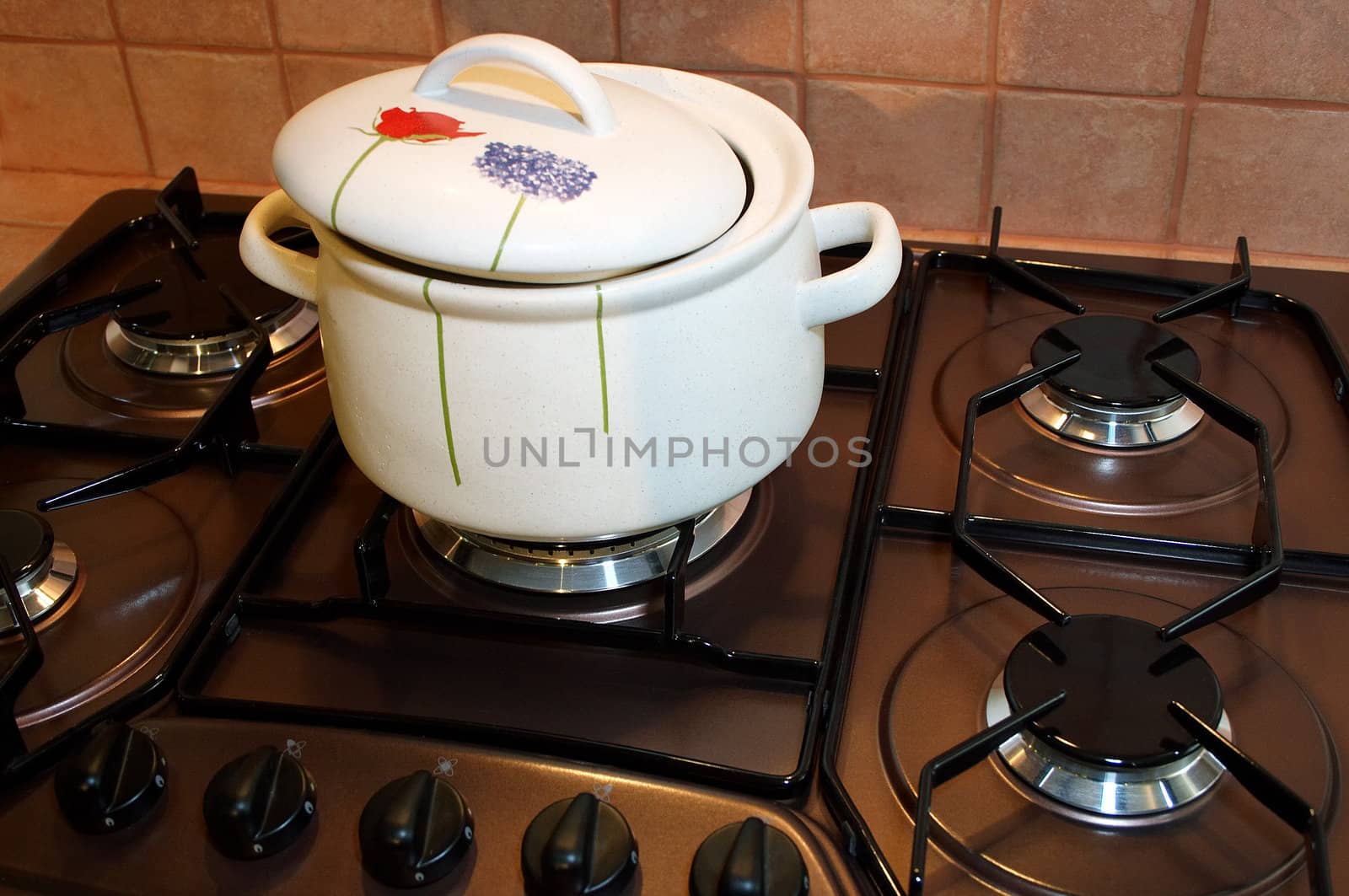 Greater white saucepan on a gas cooker