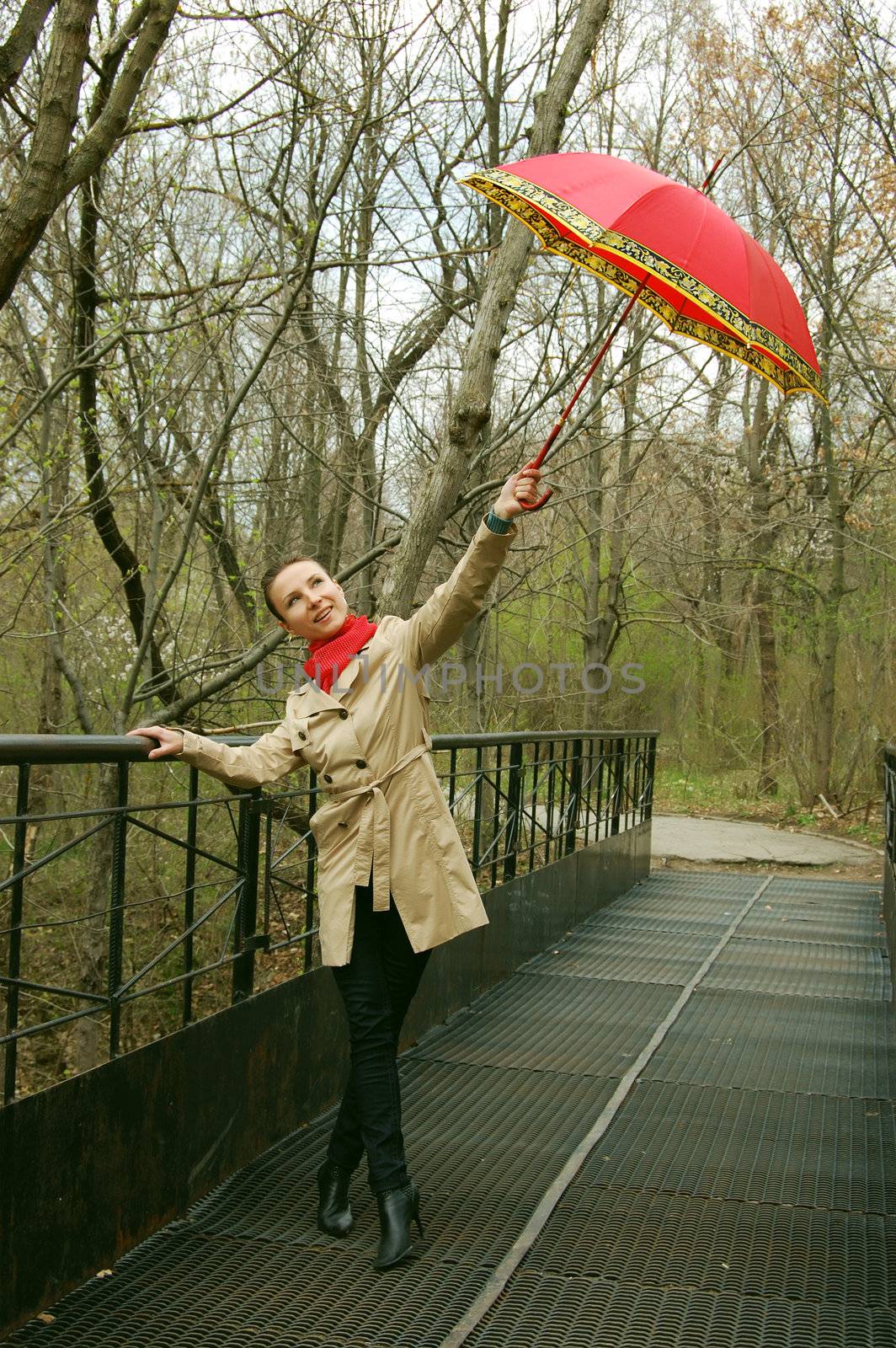 gilr on the bridge with red umbrella