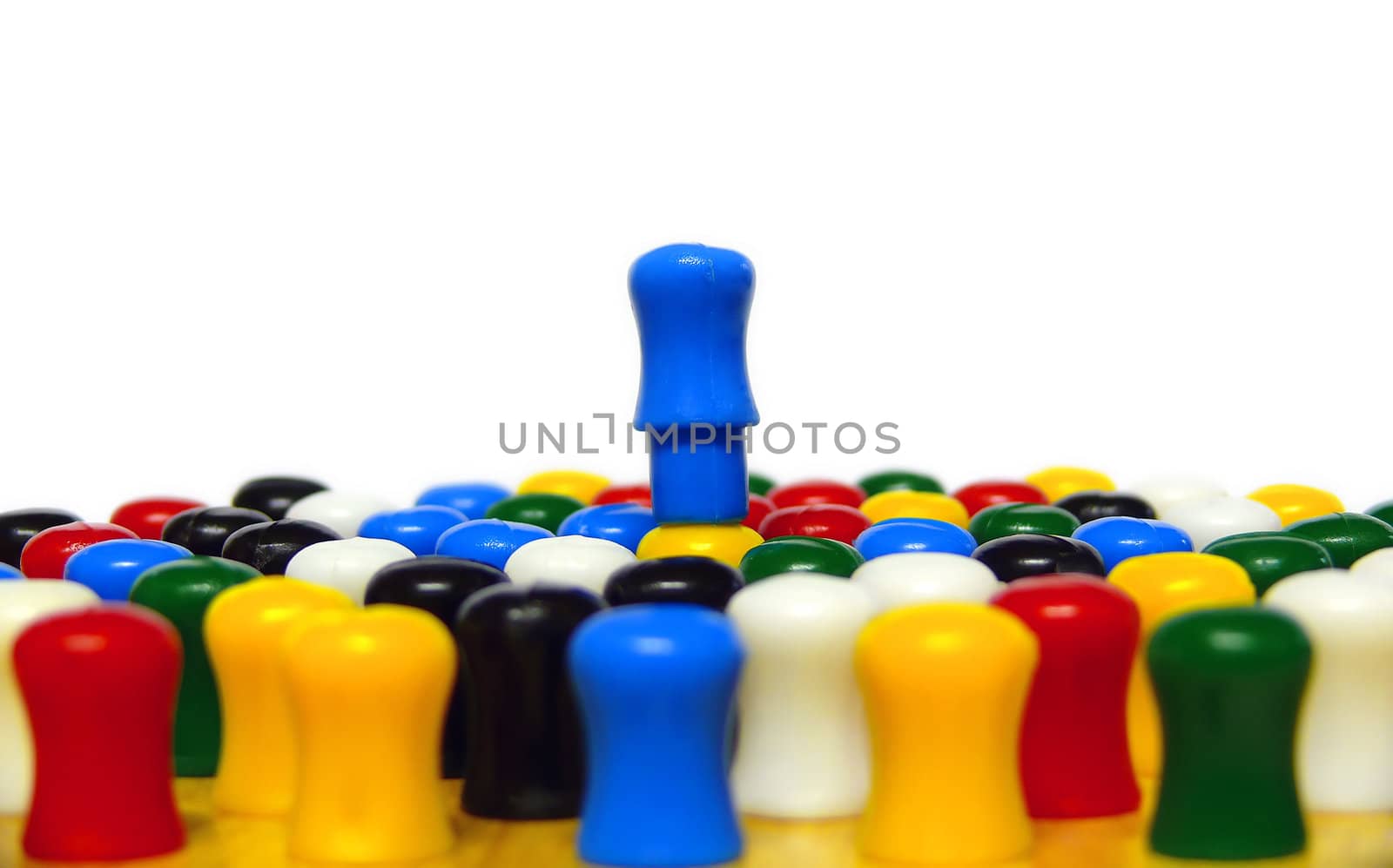 Pegs on a chinese checkers board conceptually depicting someone being on top of it, being the best