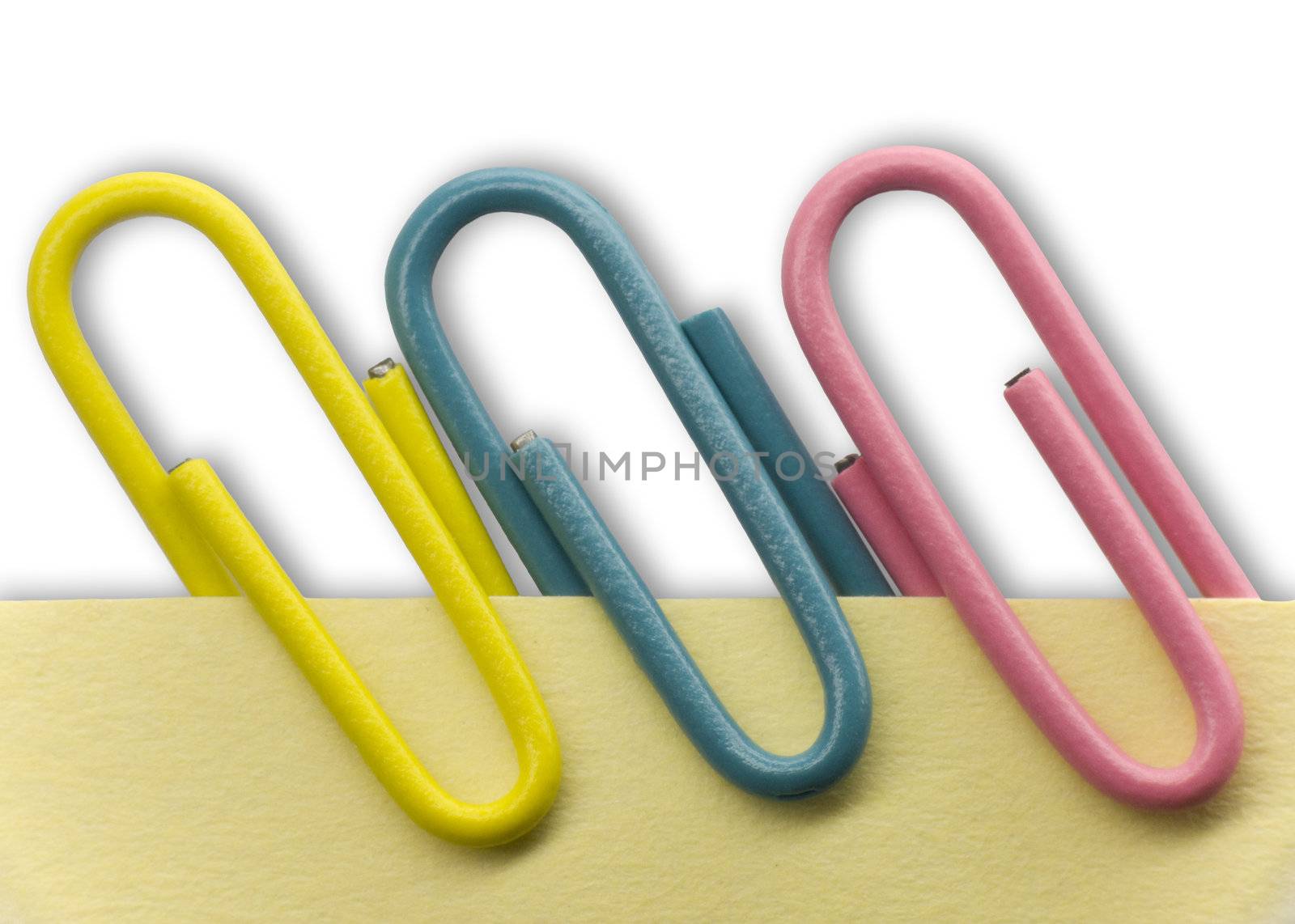 Paperclips on a yellow note with white background and shadow