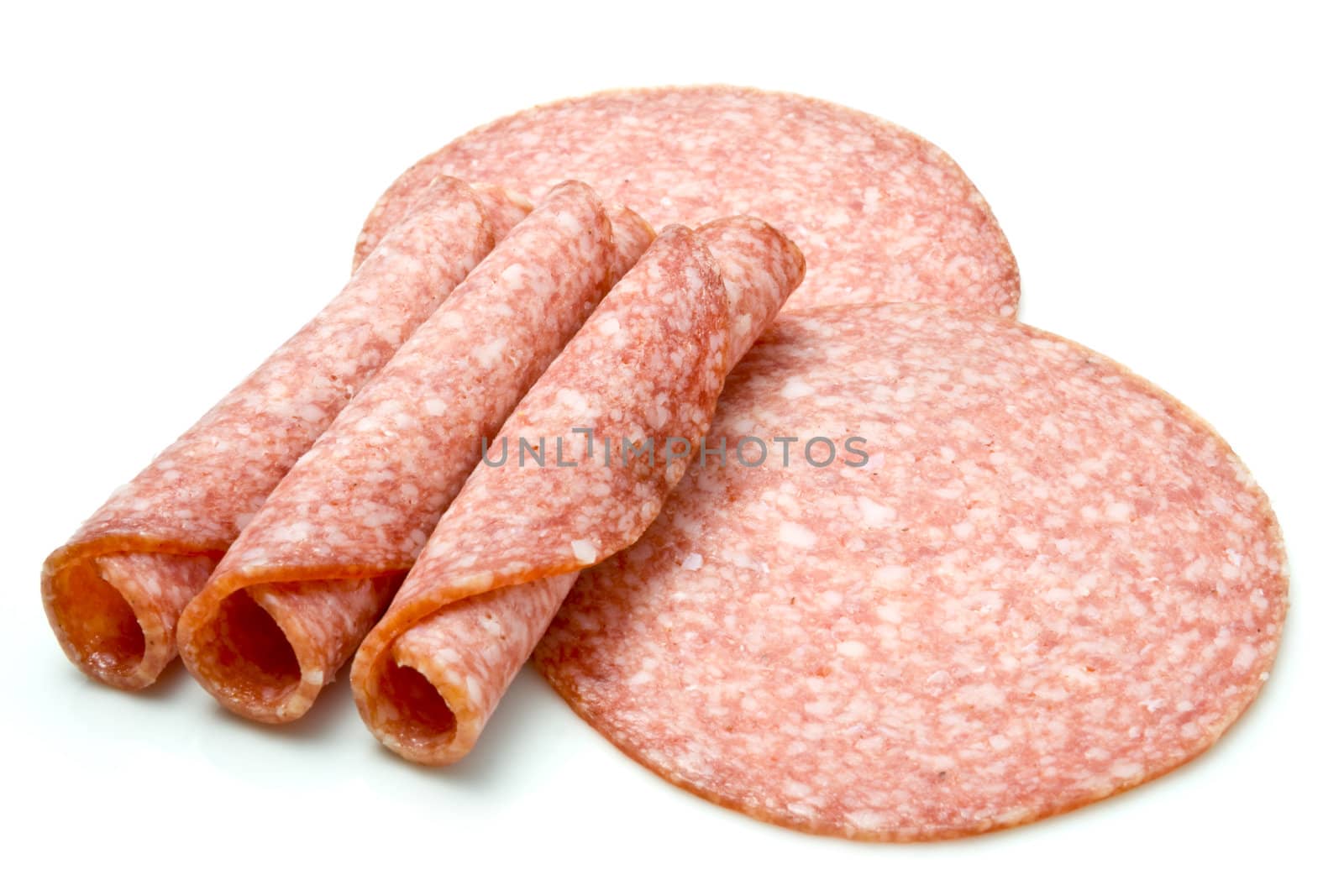 Slices of salami isolated over white background