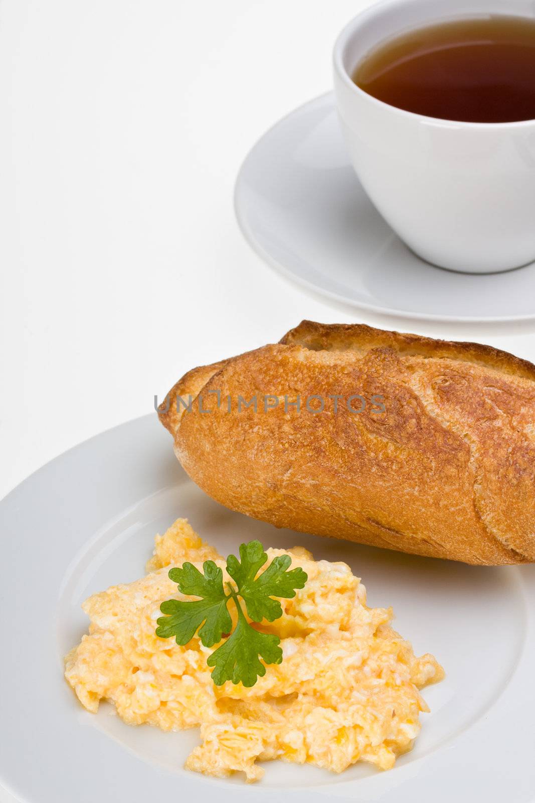 scrambled eggs and bun on a plate