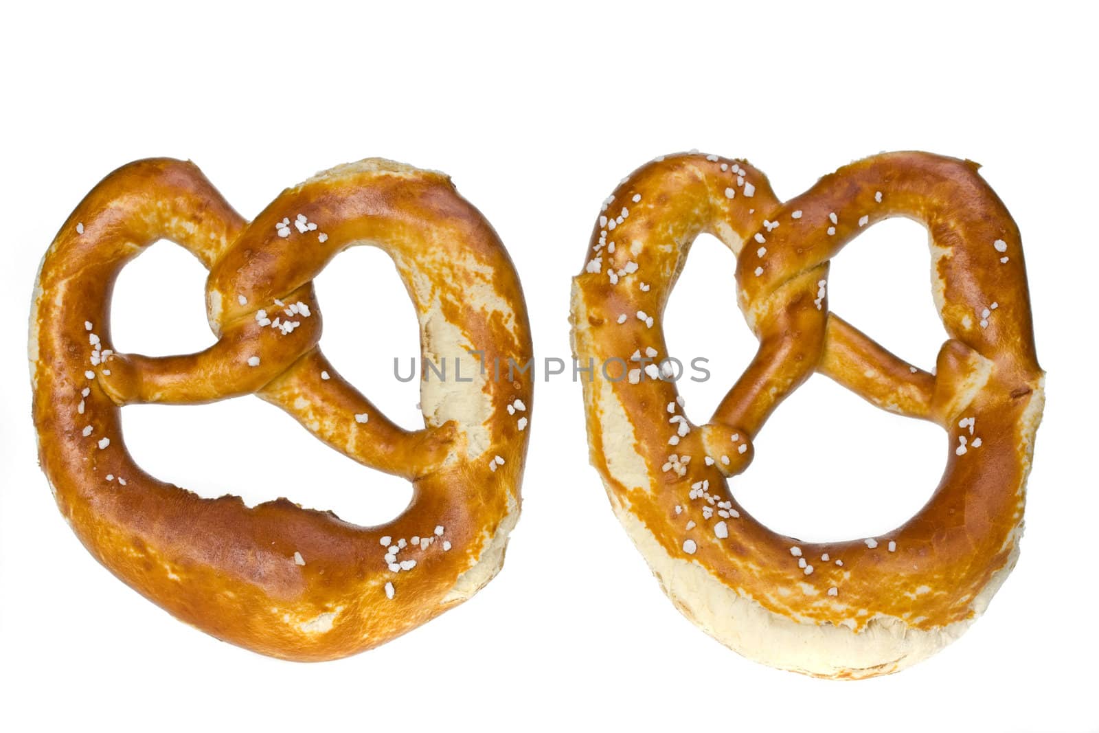 two bavarian pretzels isolated on white by bernjuer