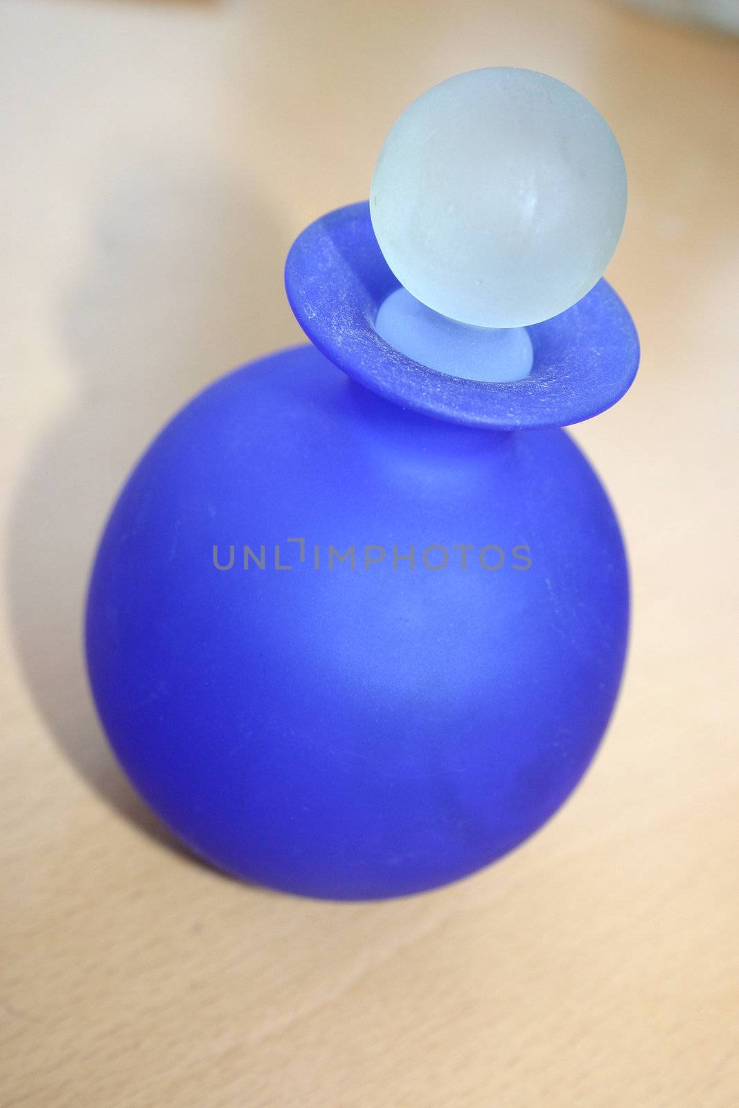 blue round stoppered glass bottle