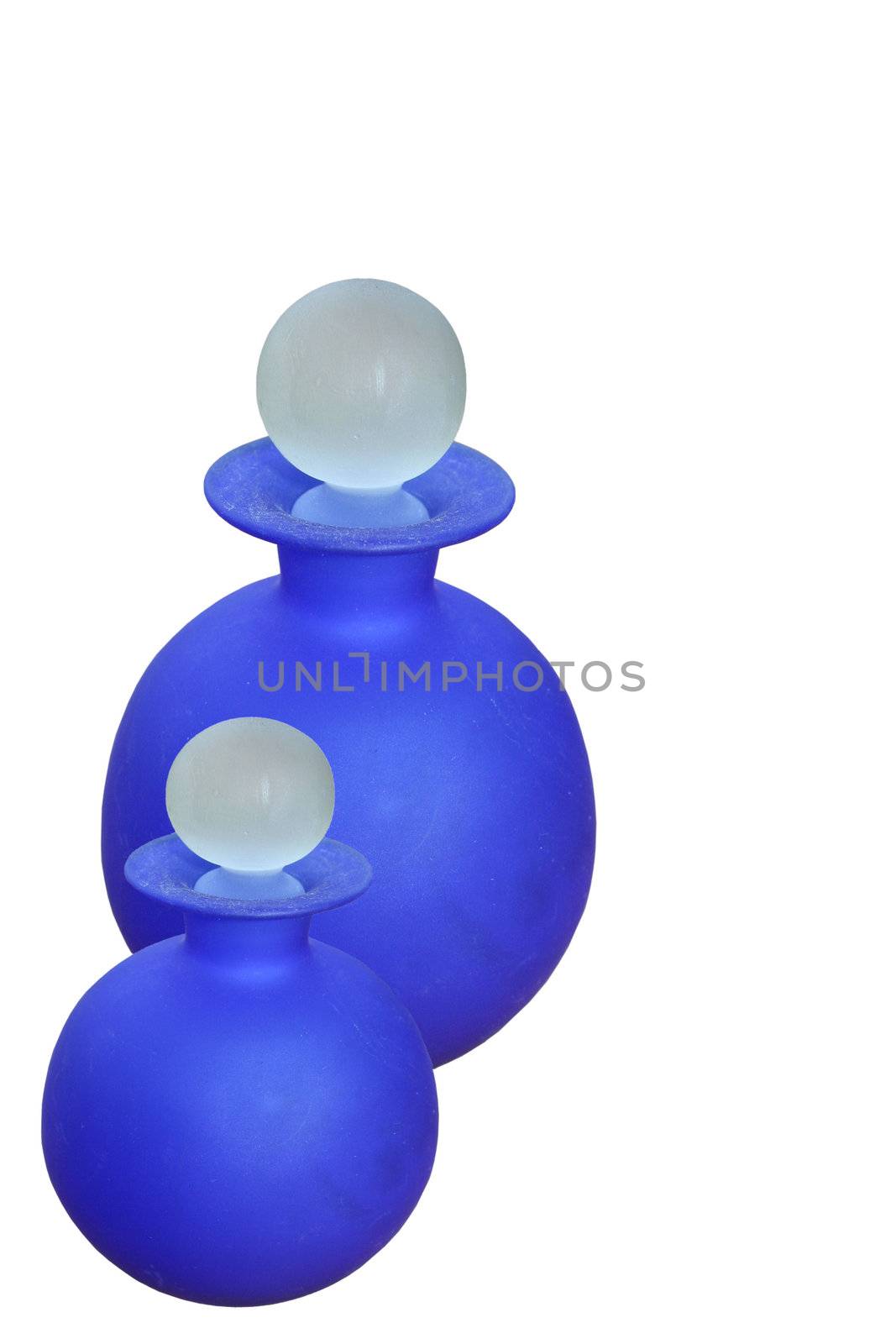 two glass round blue bottles by leafy