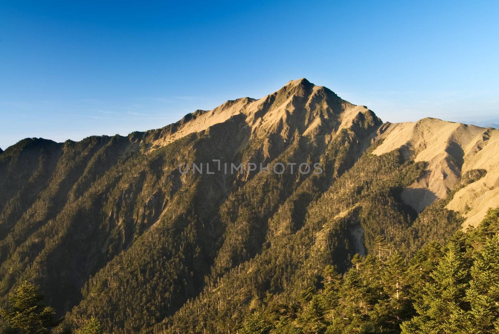 high mountain with blue sky by elwynn