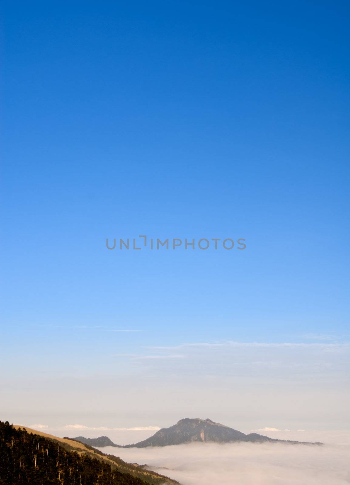 It is the mountain landscape with clouds and mist.