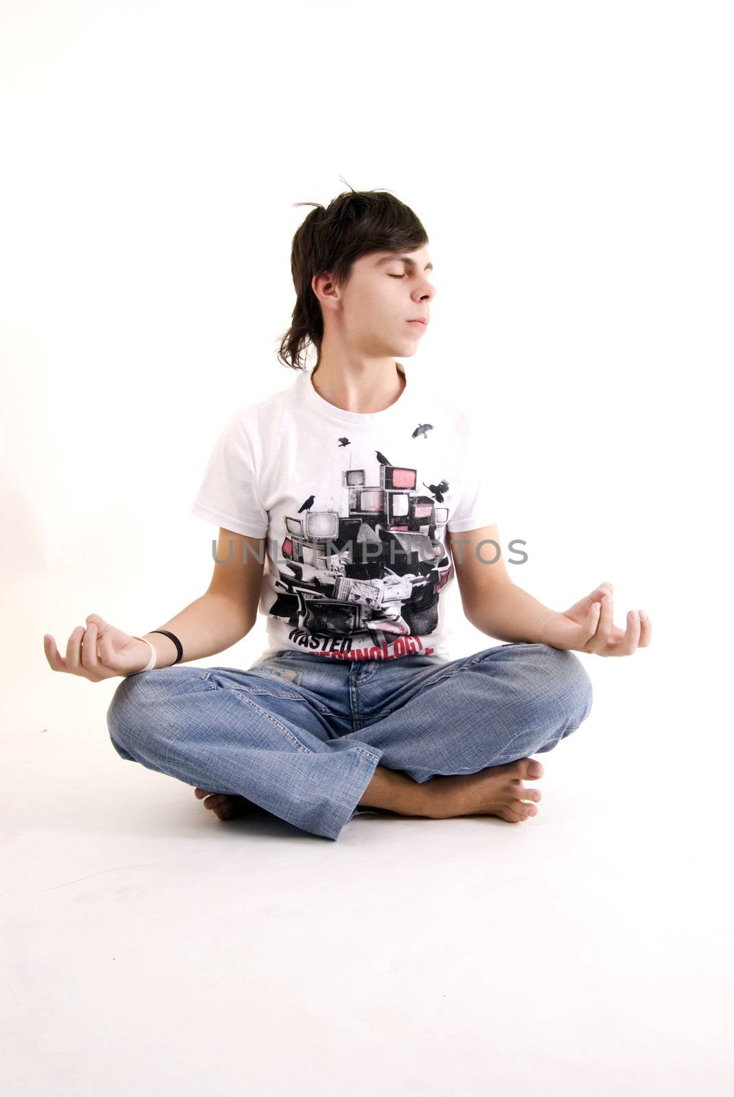 Young man meditating in the lotus pose