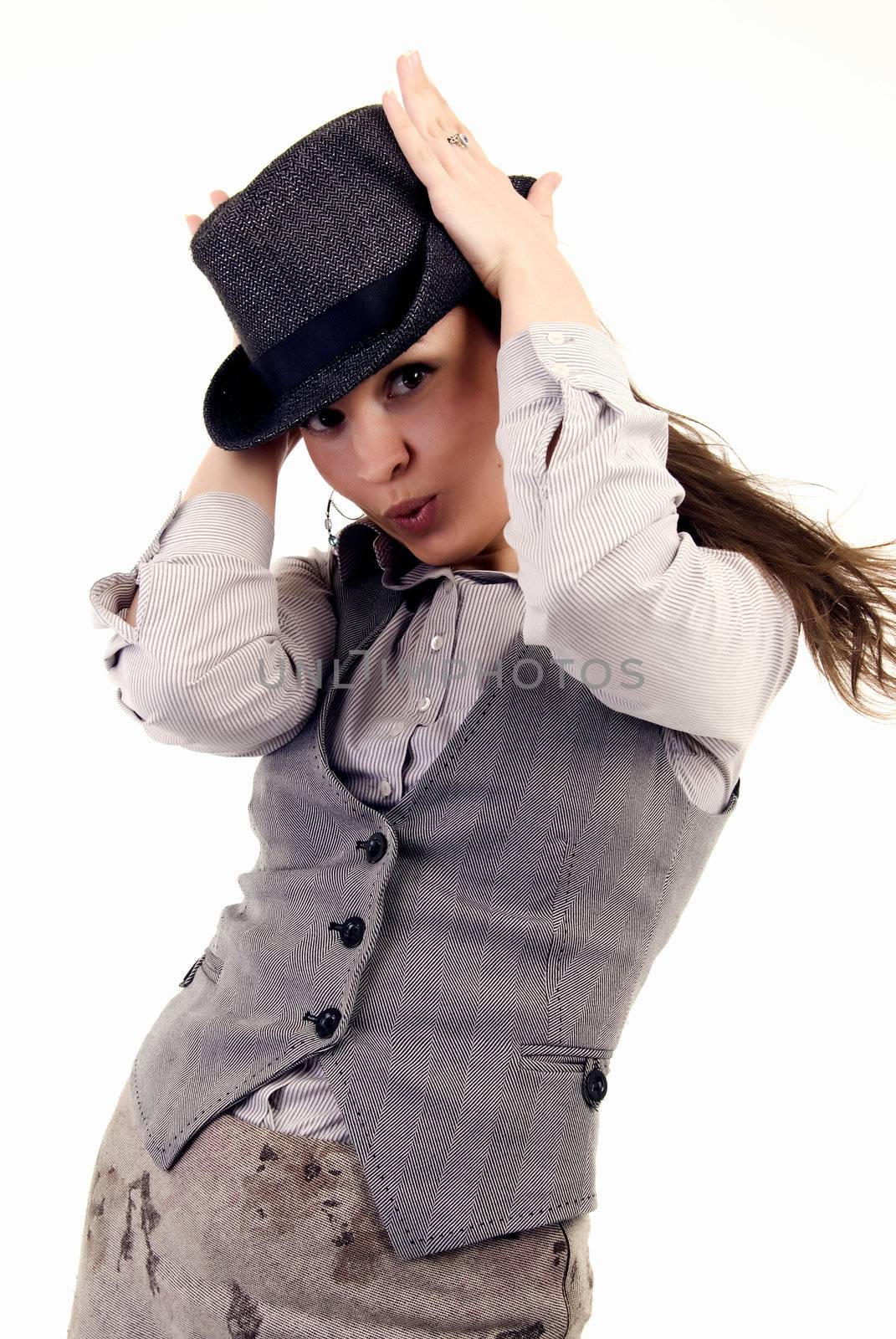 Portrait of a young coquettish brunette in hat posing