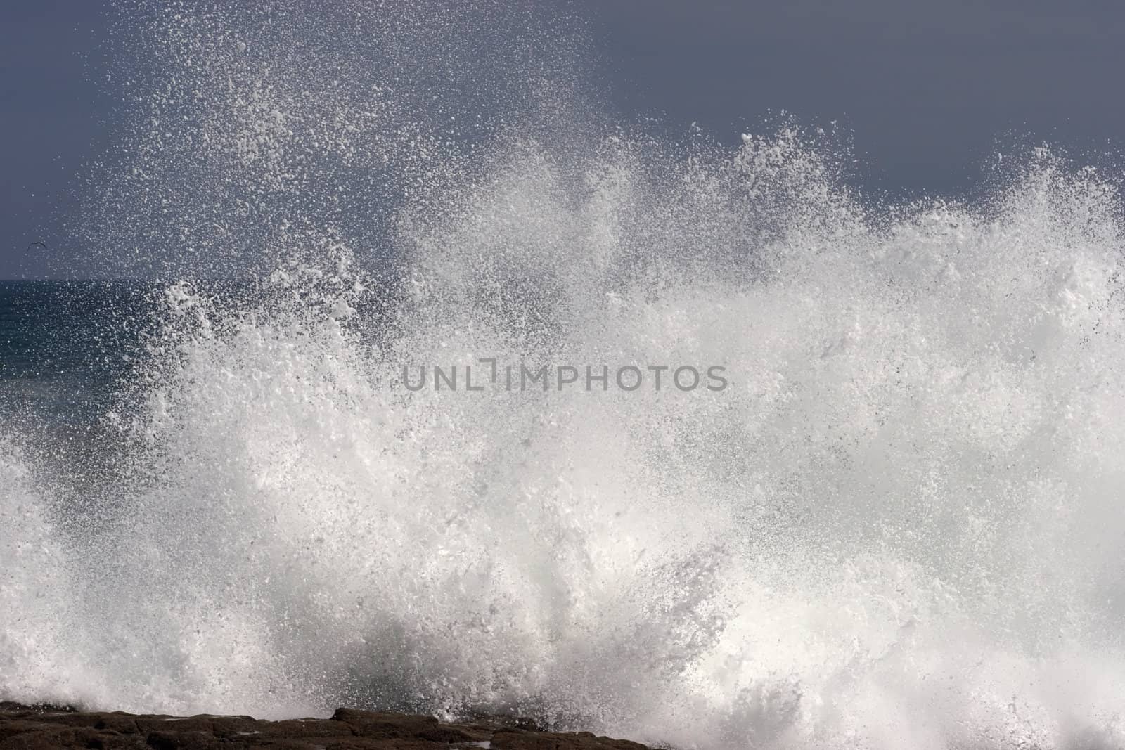 Wave hitting the shore by azotov