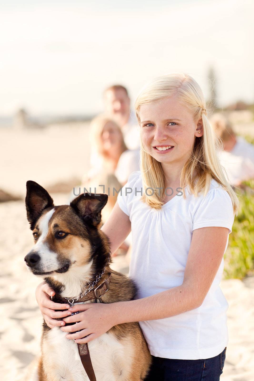 Cute Girl Playing with Her Dog at the Beach.