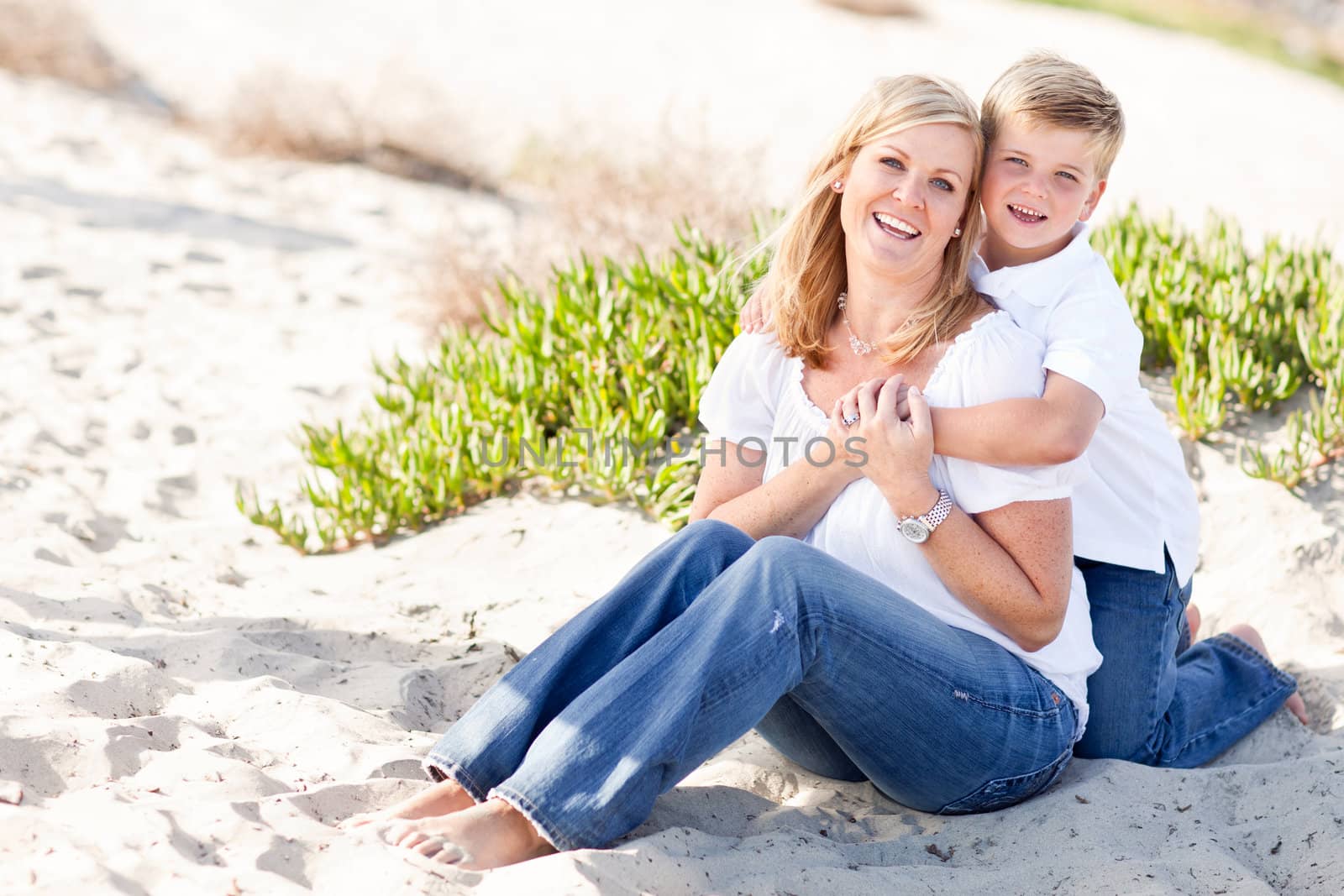 Cute Son Hugs His Attractive Mom Portrait at The Beach.