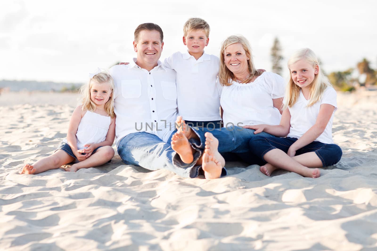 Happy Caucasian Family Portrait at the Beach One Sunny Afternoon.