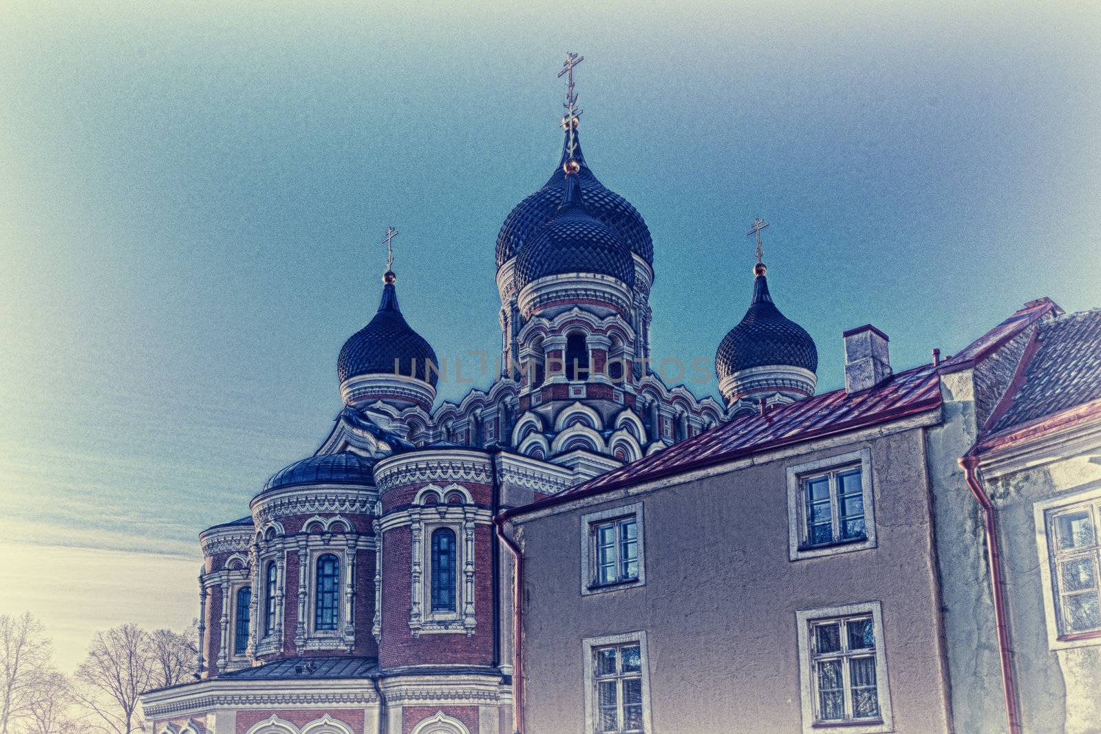 Greek Orthodox cathedral of Alexander Nevsky in Tallinn Estonia over the tops of old houses and the town wall. Taken in HDR to enhance detail and turn into a sketch