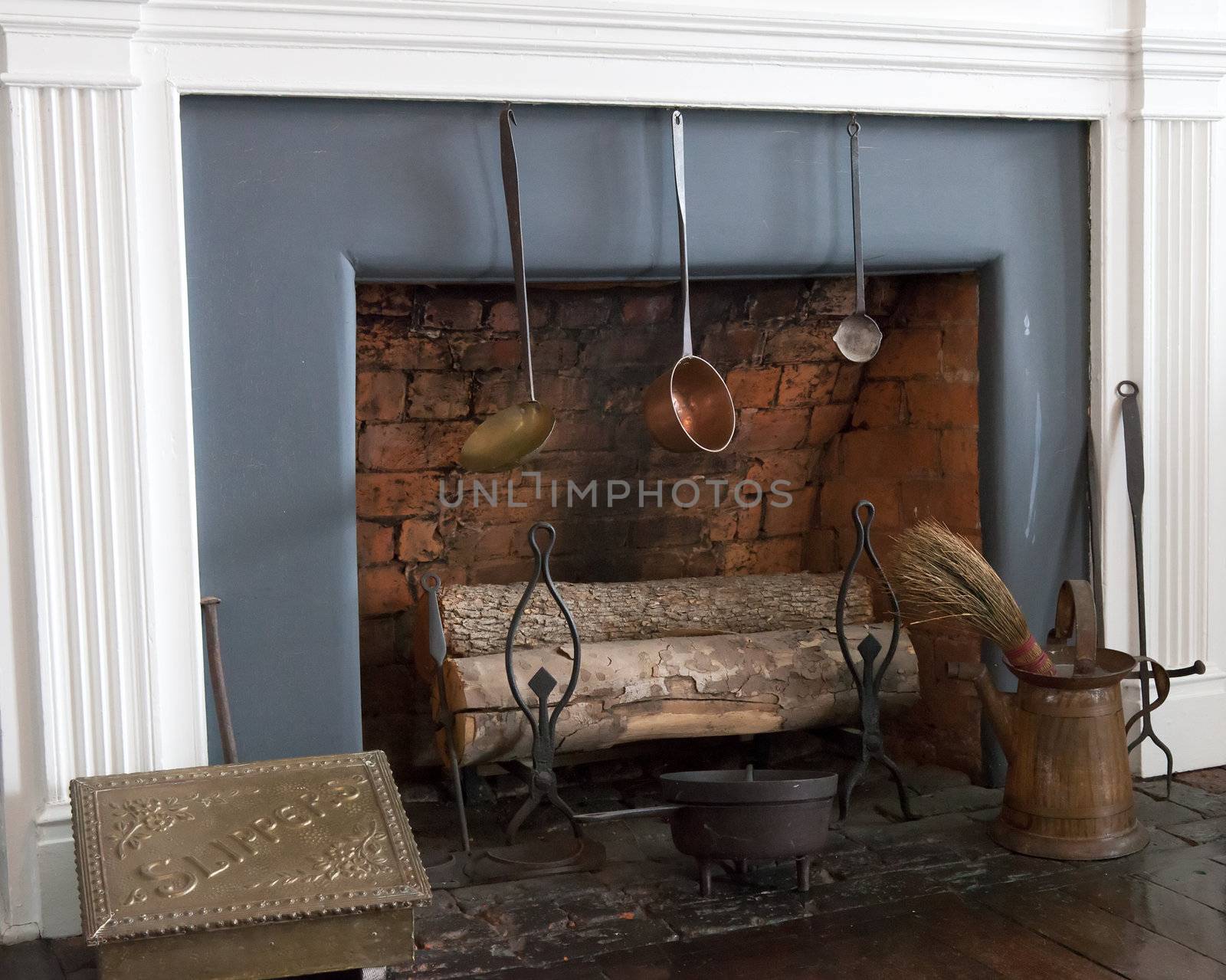 Logs standing in old fireplace in 19th century house